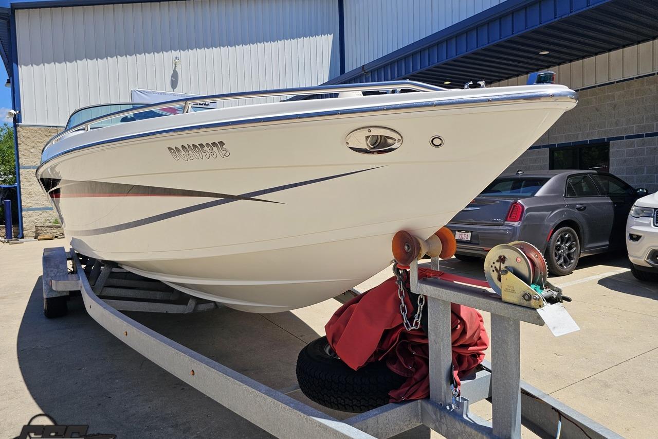 2005 Formula 271 FASTech boat on trailer, parked outdoors.