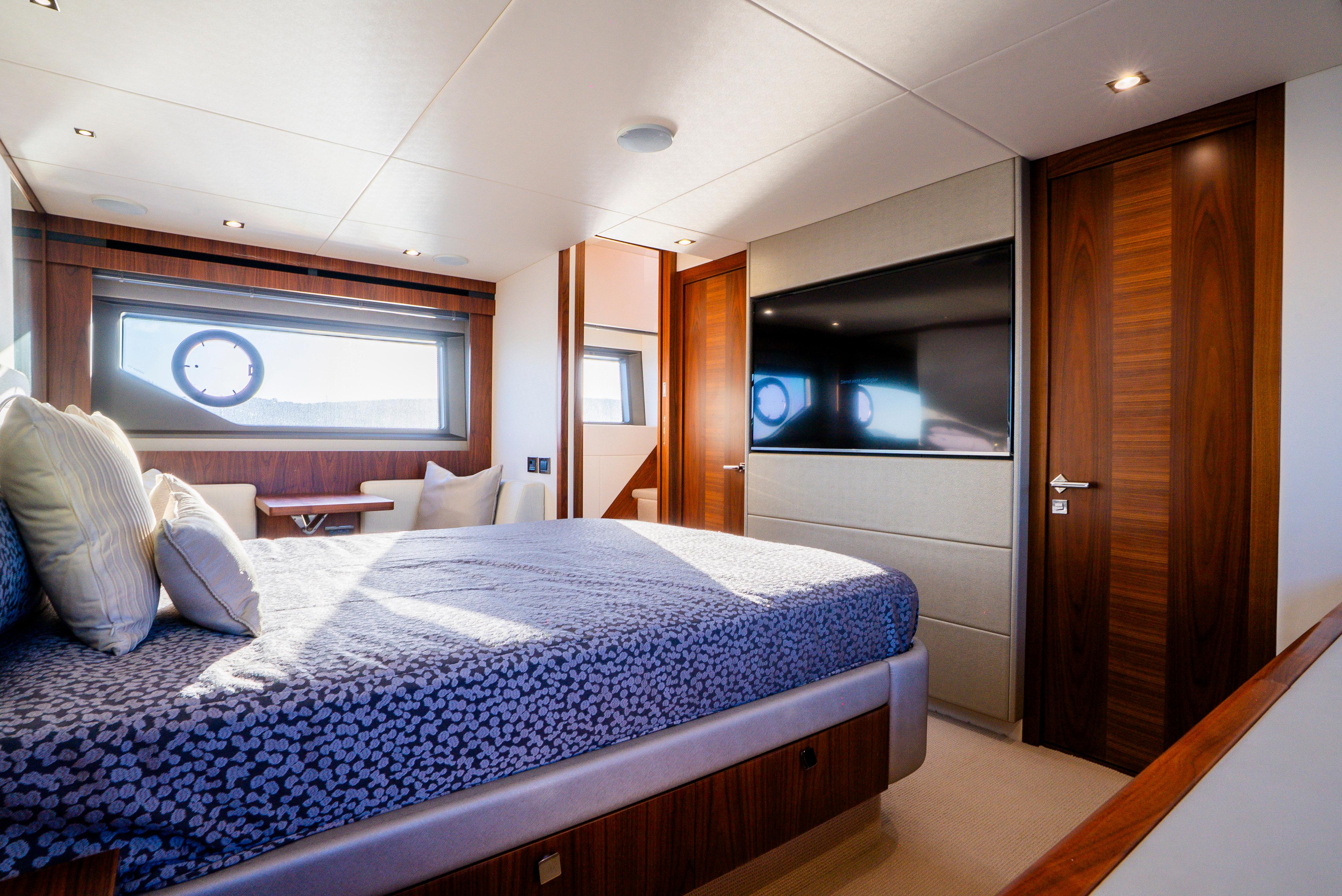 Luxurious bedroom interior of 2017 Sunseeker Manhattan 66 yacht with modern design.