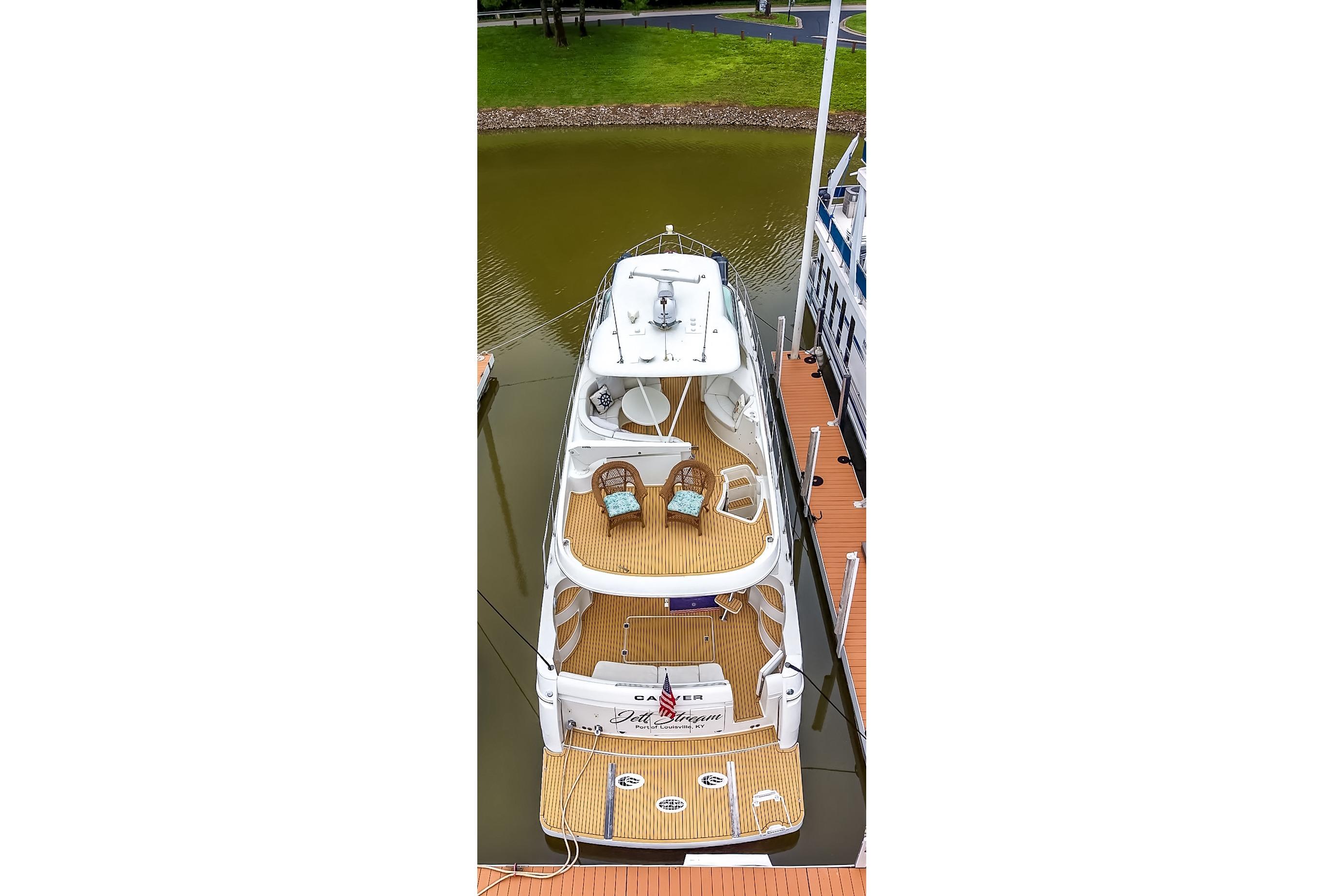 2006 Carver 56 Voyager yacht docked, aerial view showcasing spacious decks and seating areas.