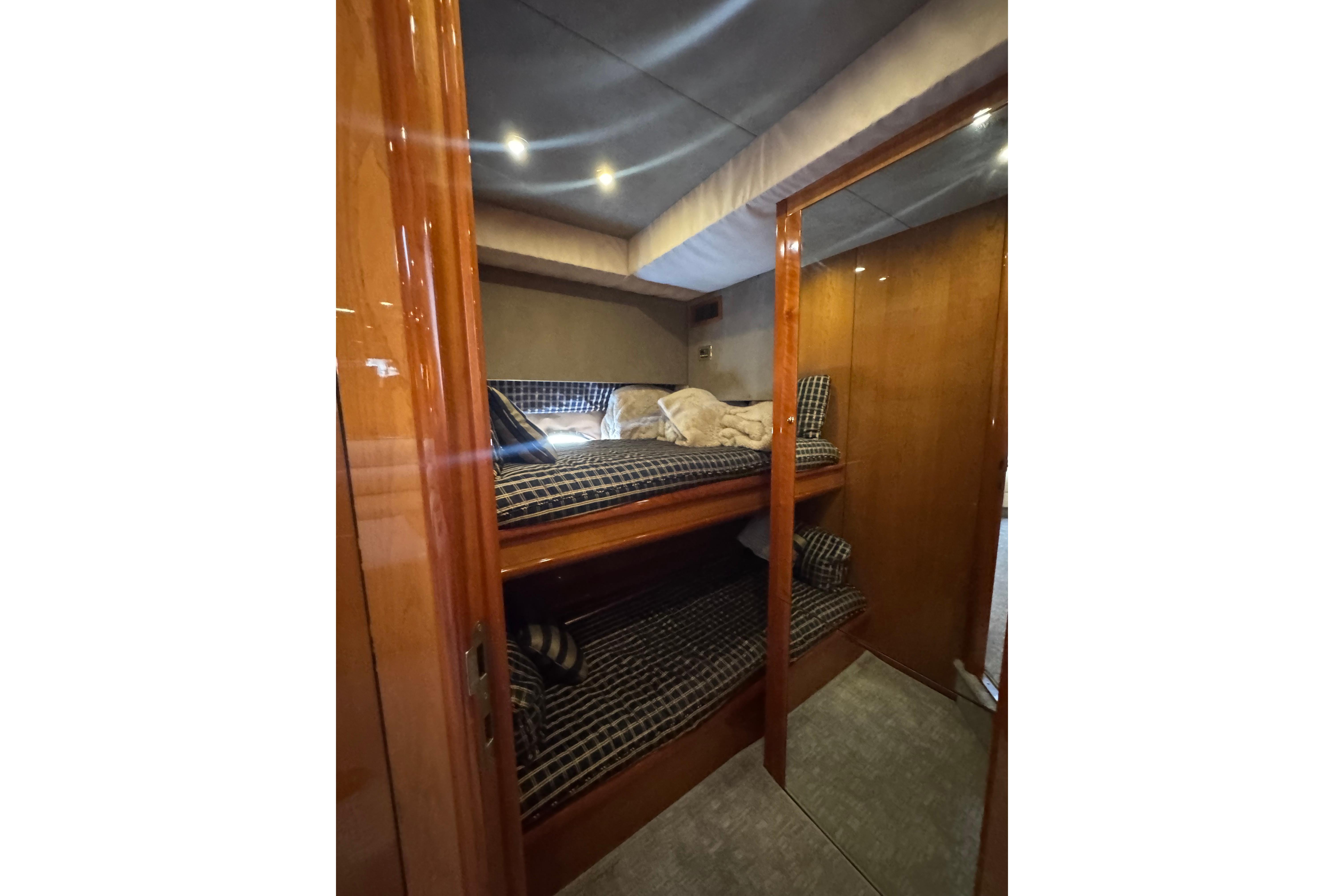 Interior cabin of 2004 Sunseeker Predator 68 yacht with wooden finish and bunk beds.