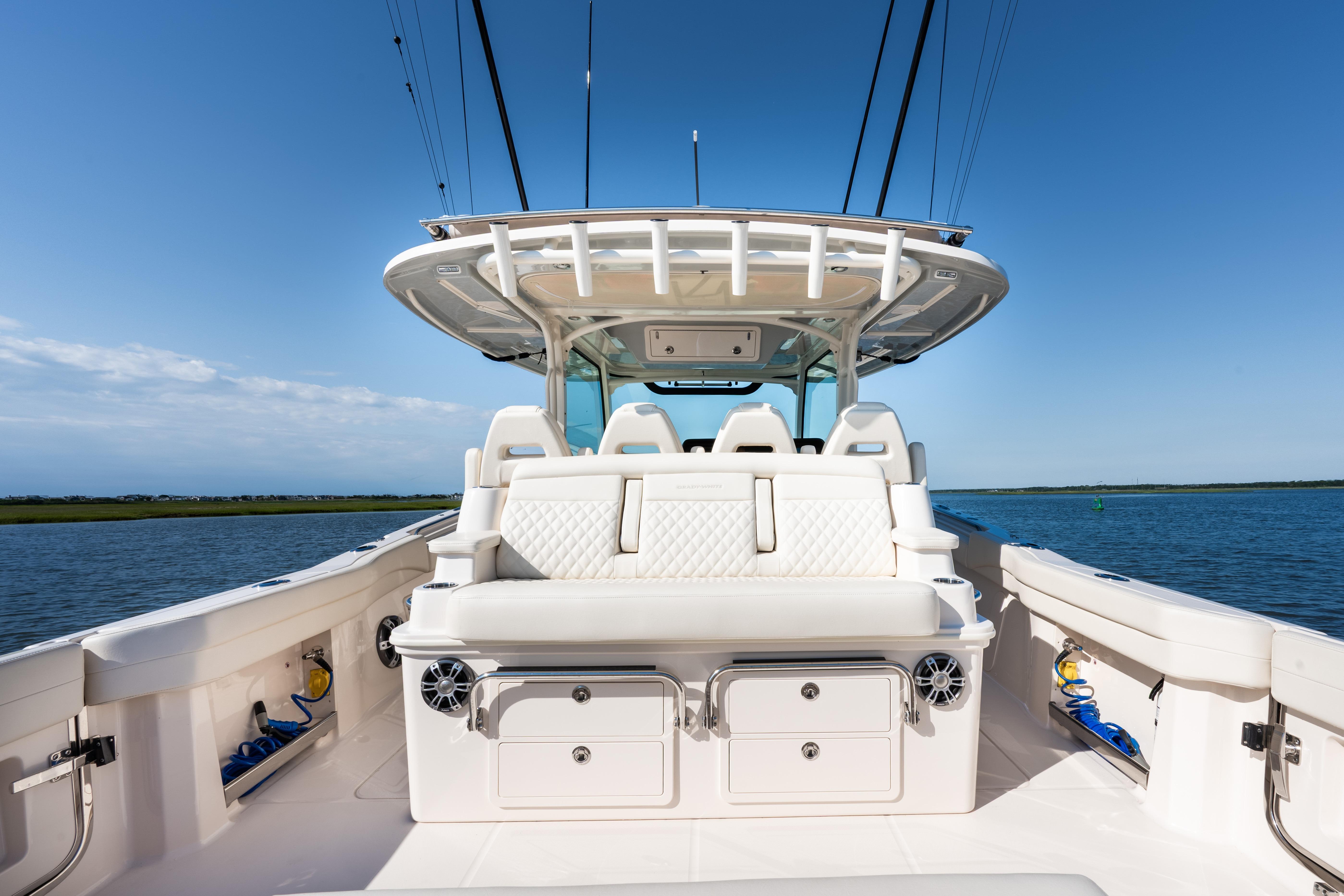 2025 Grady-White Canyon 386 boat interior with seating, ocean view, and clear sky.