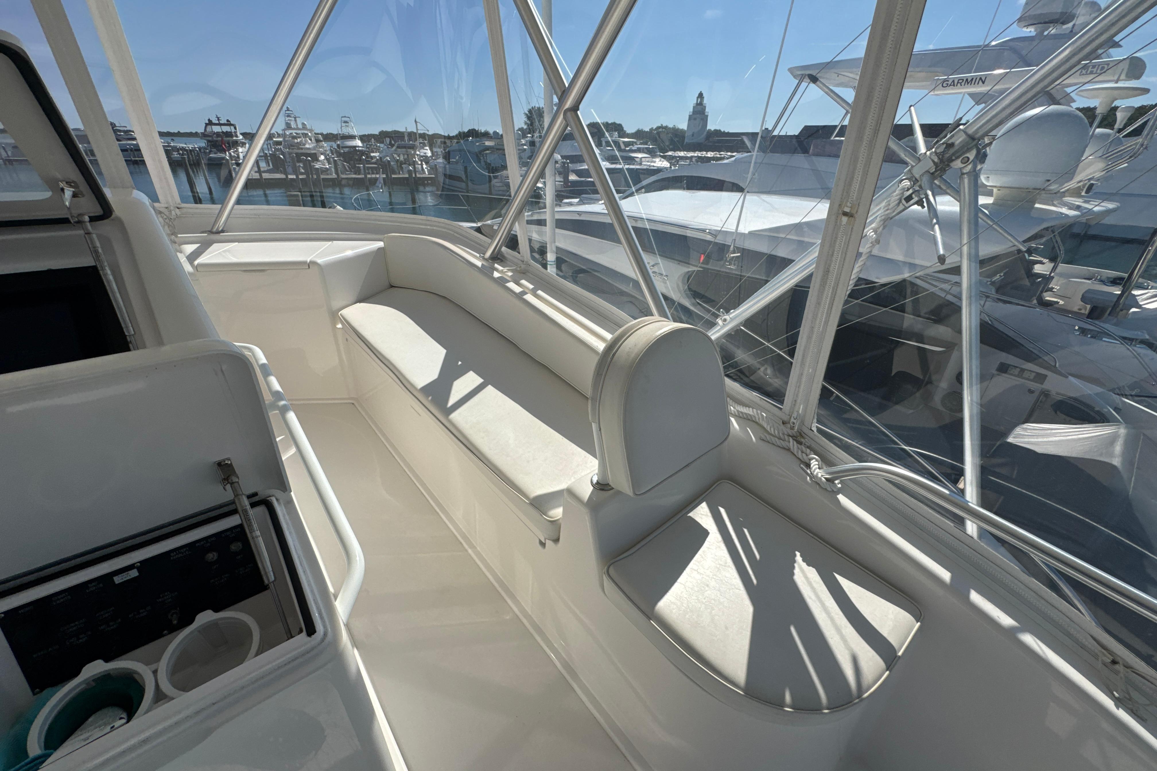 2006 Viking 56 Convertible yacht interior with white seating and marina view.