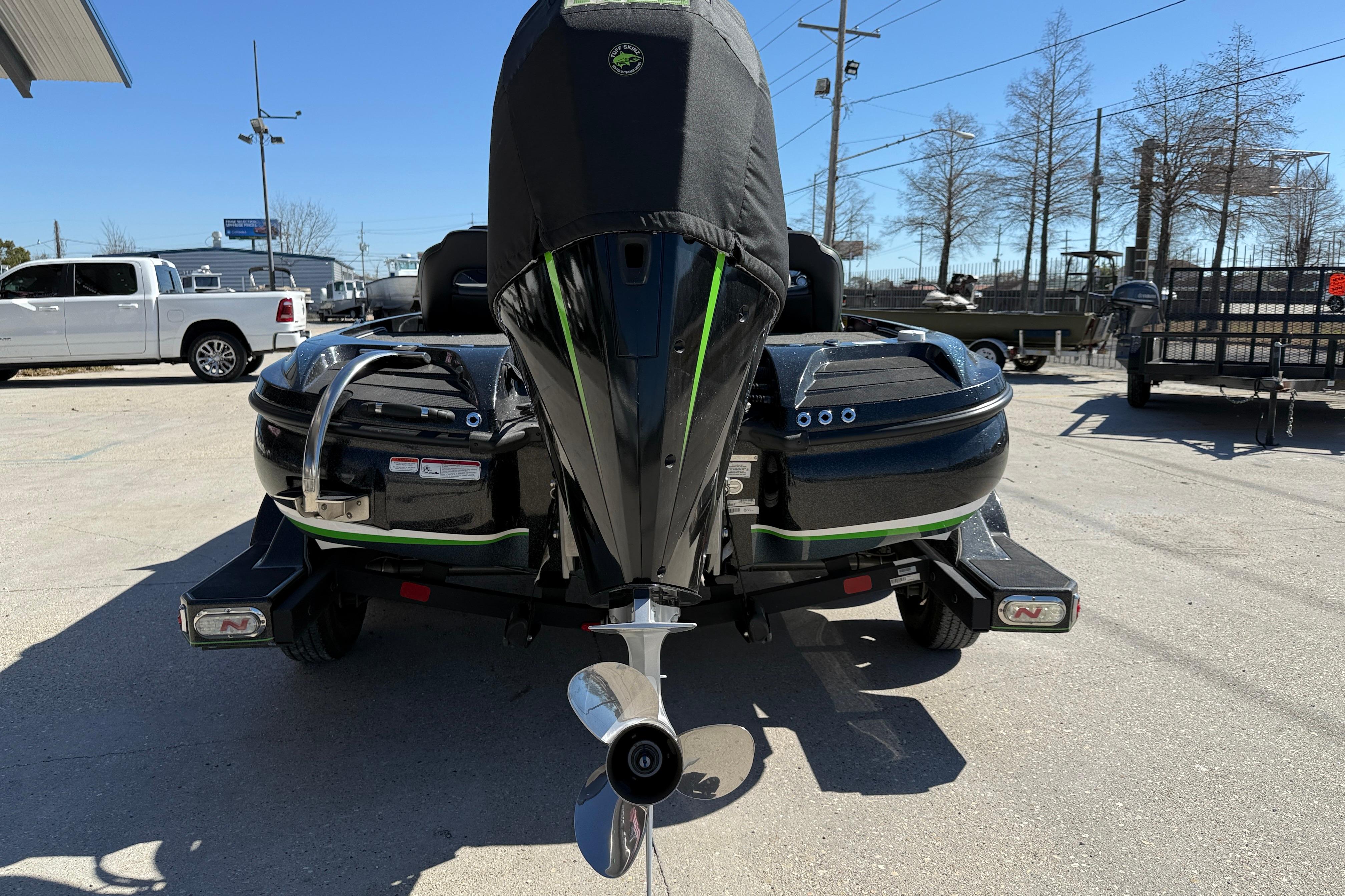 2020 Nitro Z20 boat on trailer, rear view with covered engine, parked outdoors.