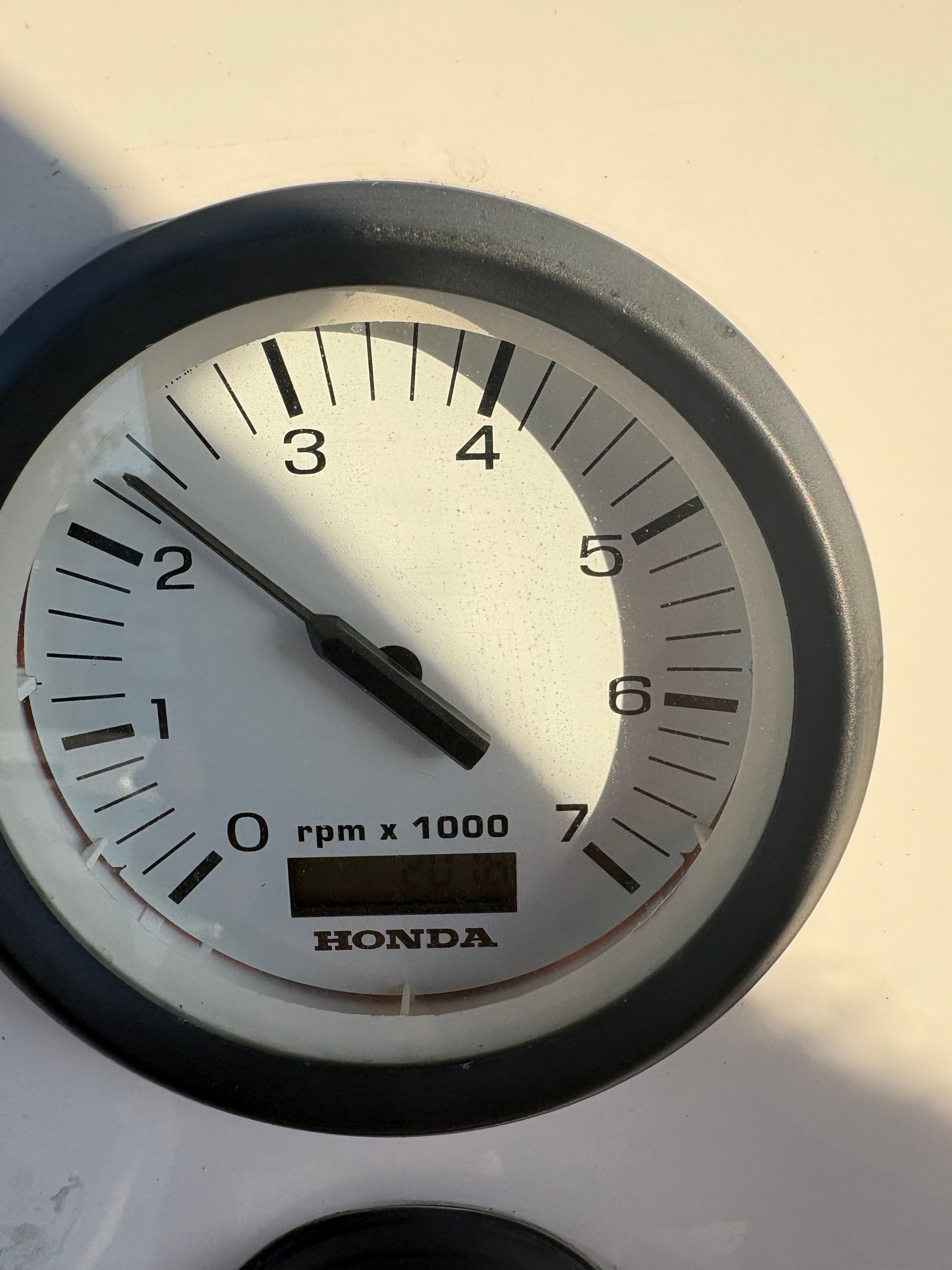 A Honda tachometer displays around 2,000 RPM.