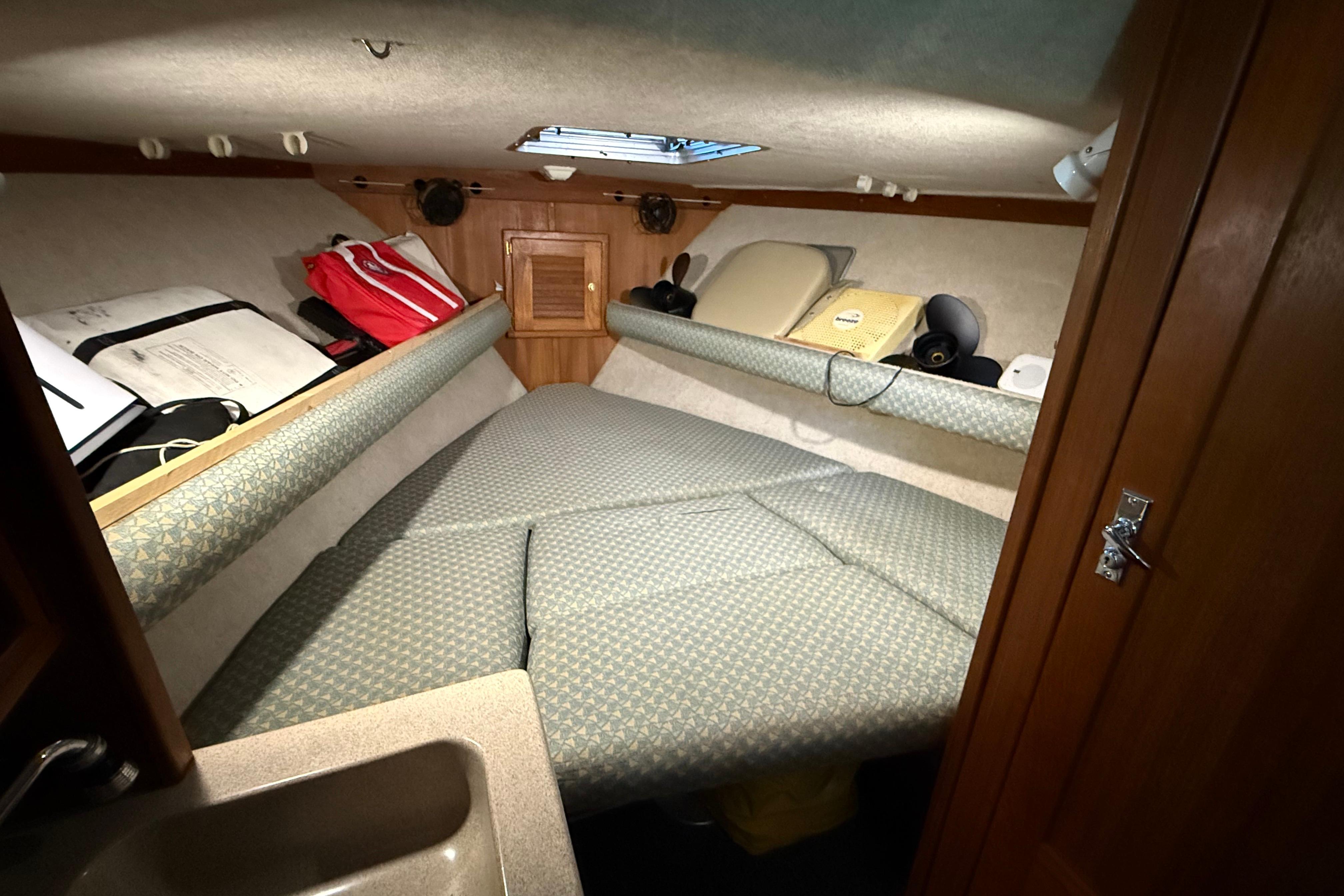 2002 Albemarle 265 Express Fisherman cabin interior with bed and storage compartments.