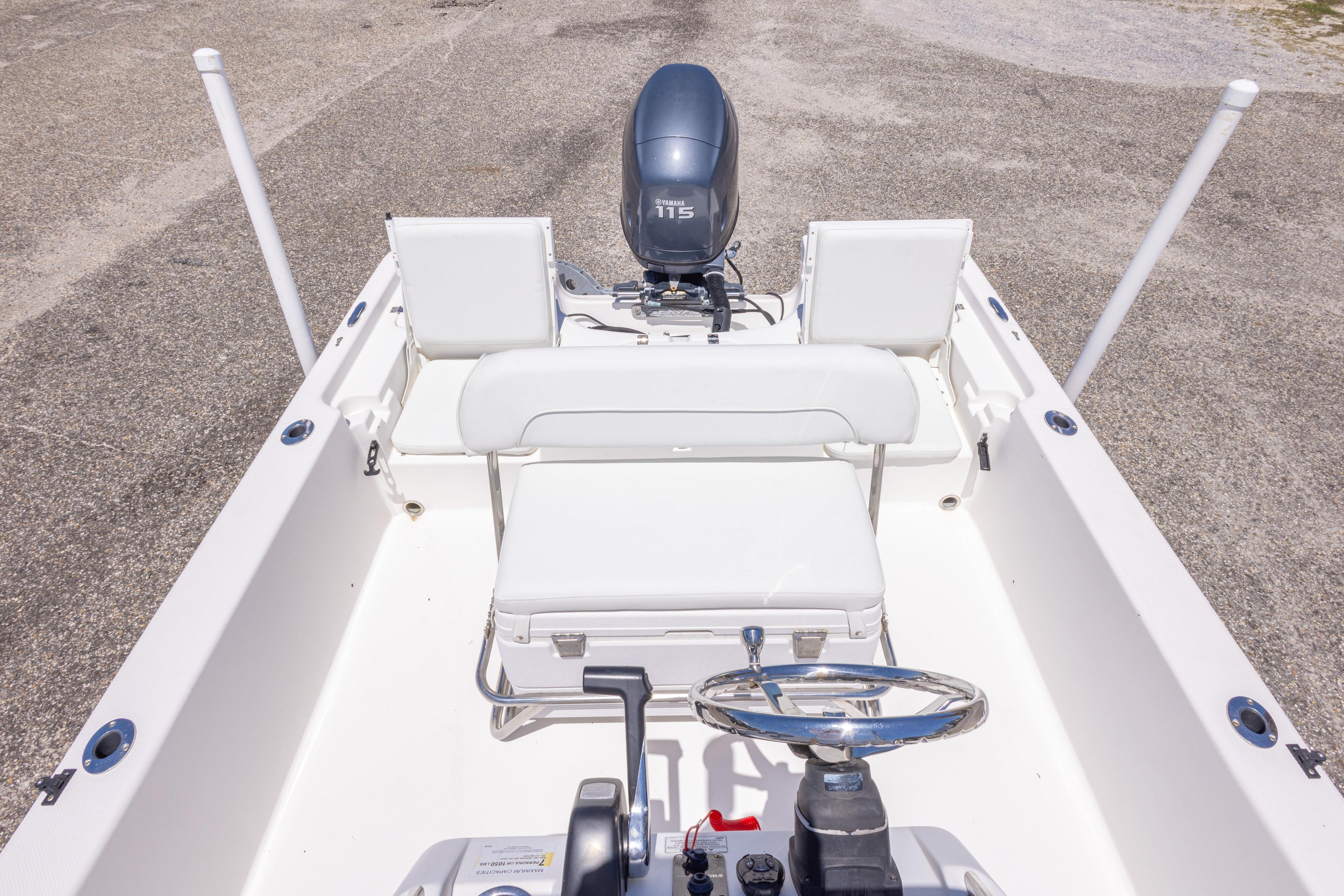 2011 Sea Fox 200XT boat interior with steering wheel and seating, featuring a Yamaha 115 engine.