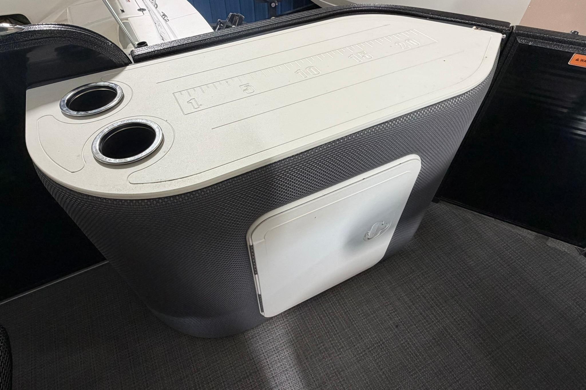 2023 Crest Classic LX 200 boat console with cup holders and storage compartment.