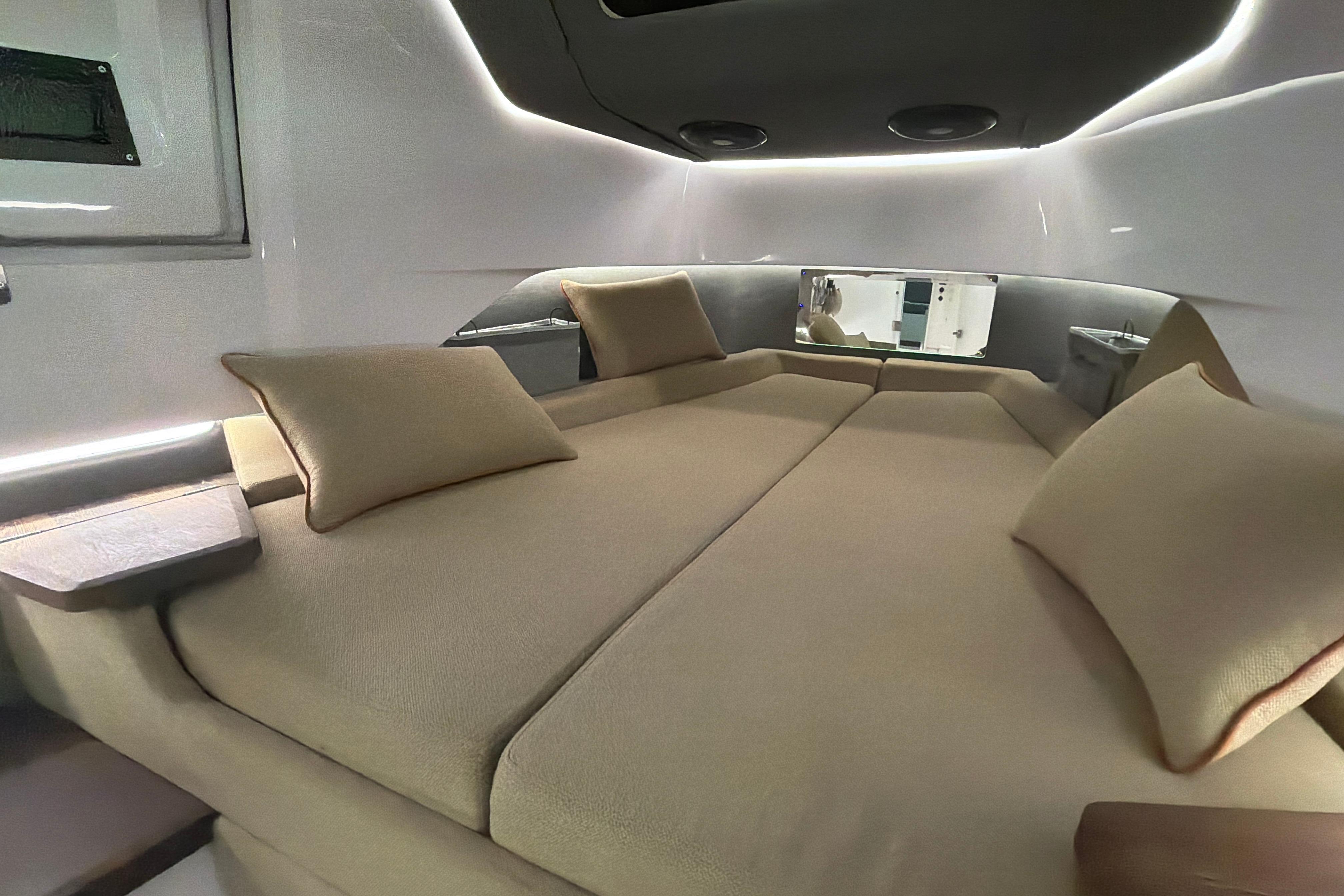 Luxurious interior cabin of 2022 Axopar Brabus 37 XC Cross Cabin with plush bedding.