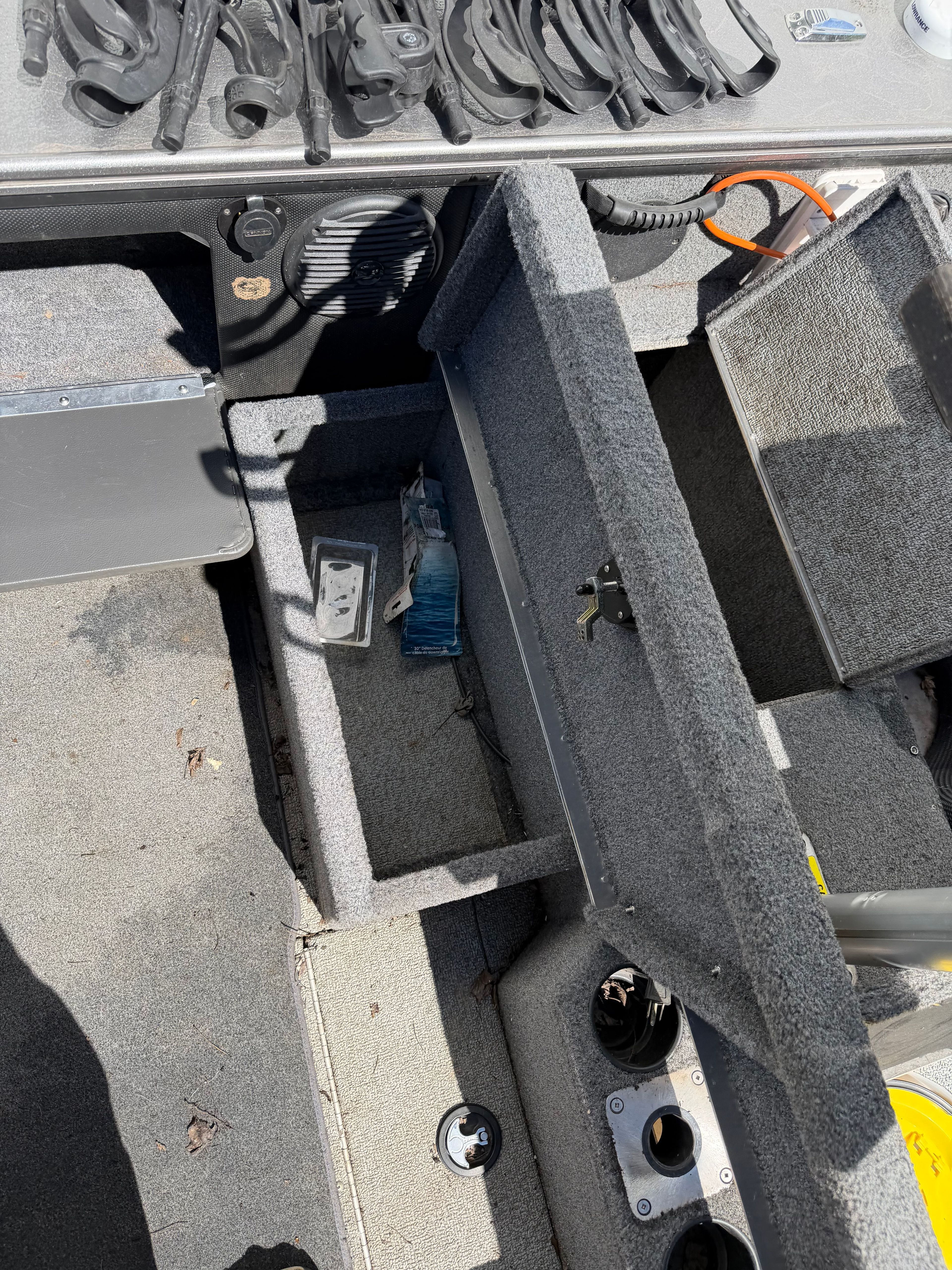 Interior of a 2017 Lund Pro V 1975 boat with storage compartment.