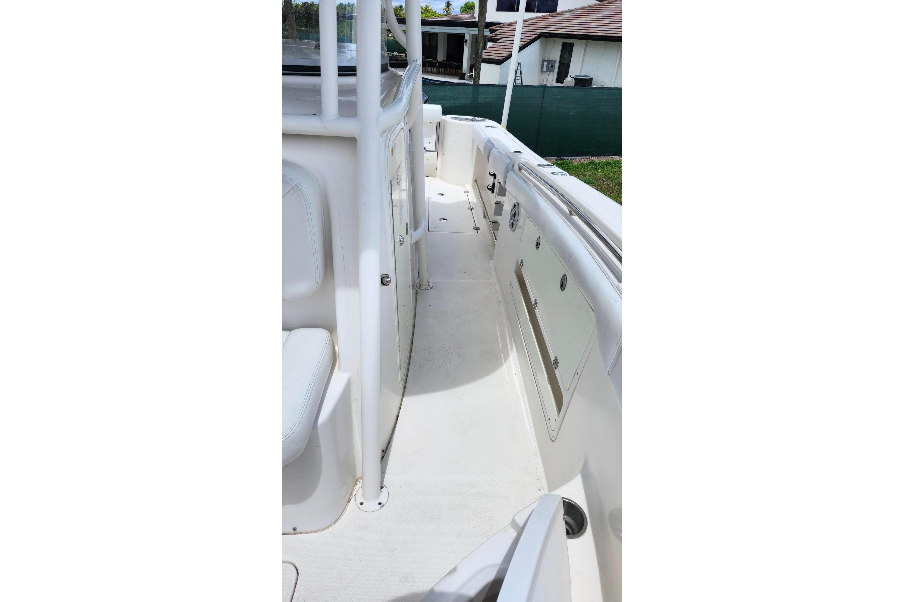 2015 Robalo R300 Center Console boat deck with seating and storage compartments.