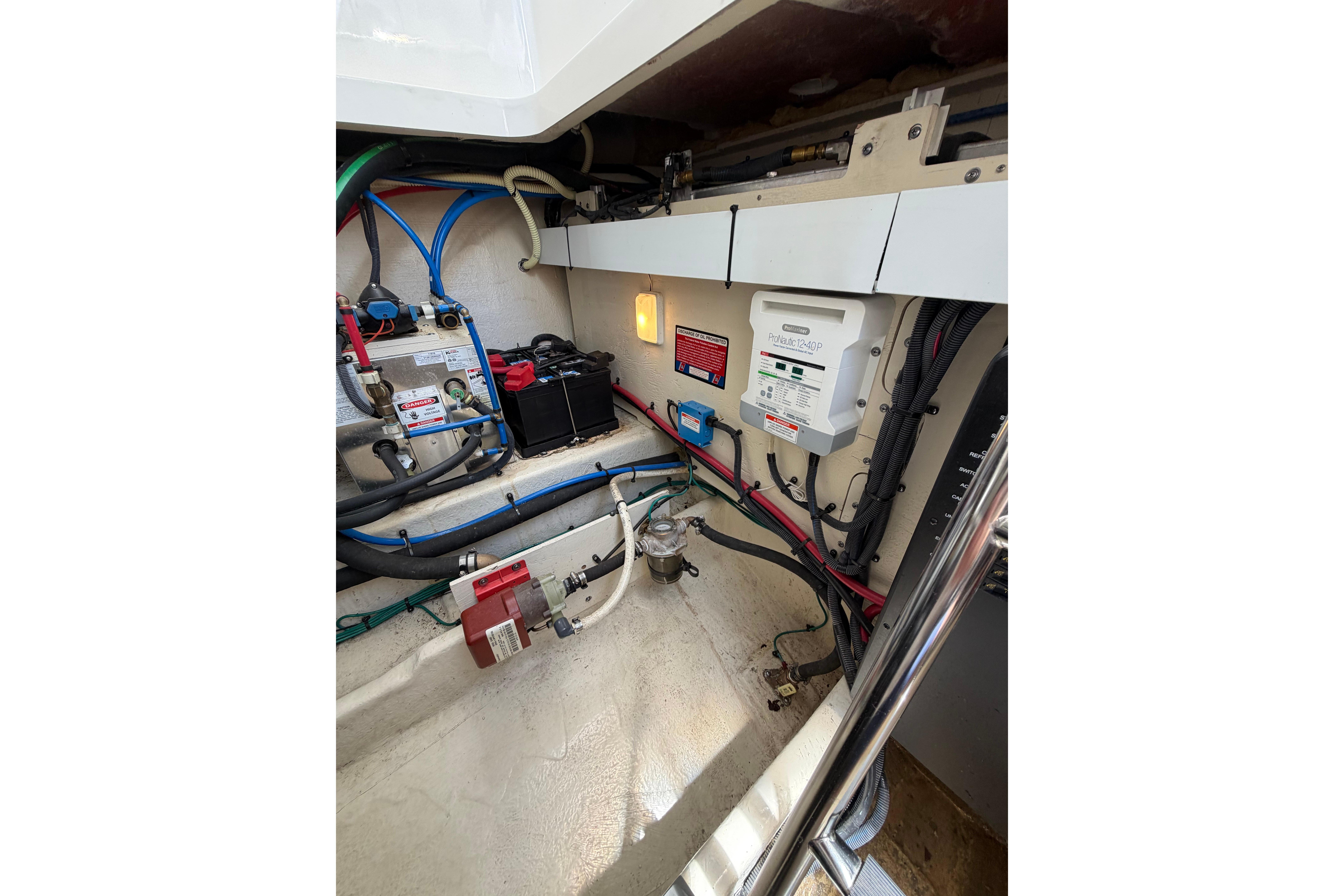 Engine compartment of a 2012 Sea Ray Sundancer 370 with electrical components and wiring.