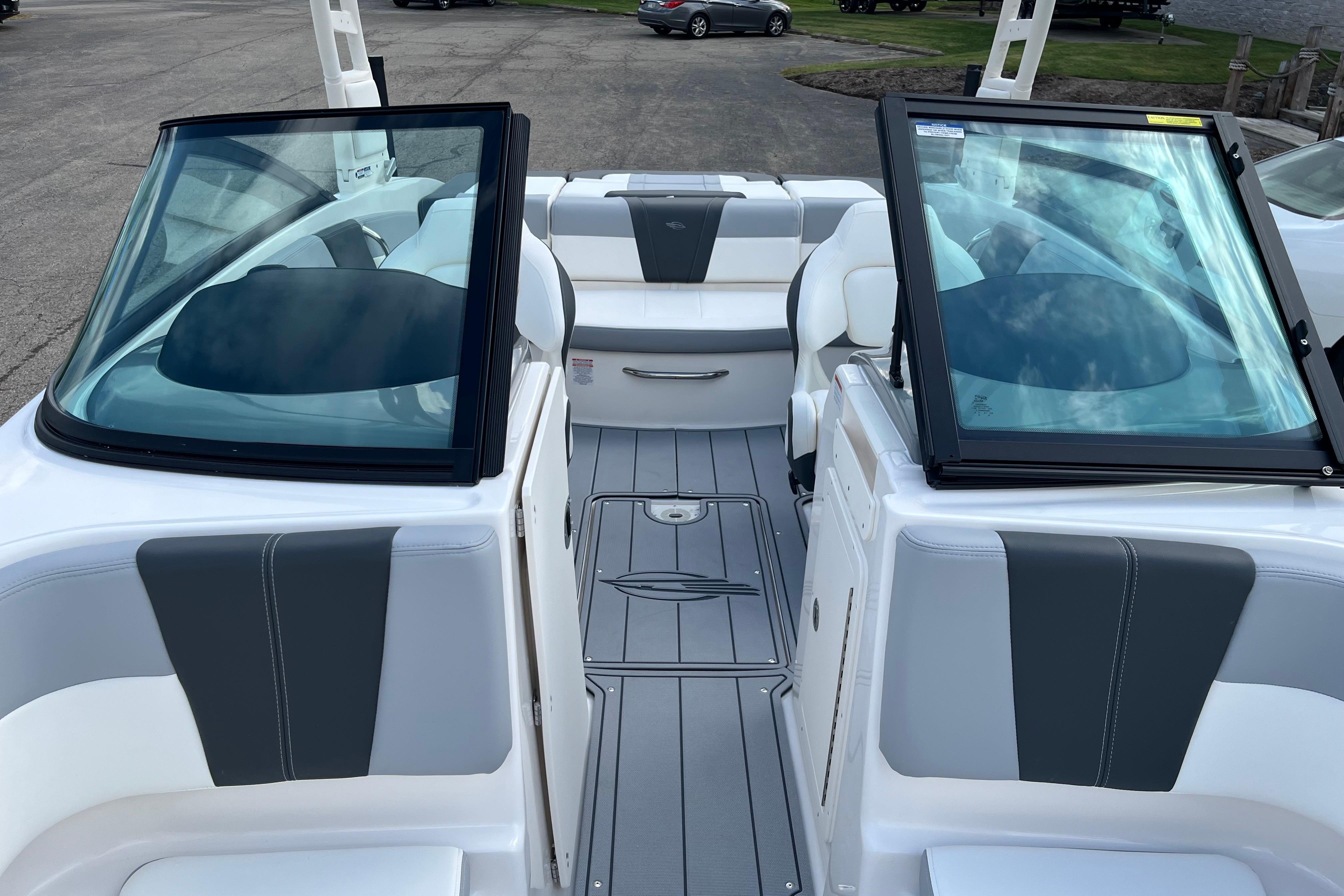 2026 Chaparral 21 SSi boat interior with gray and white seating, open windshield, and sleek design.