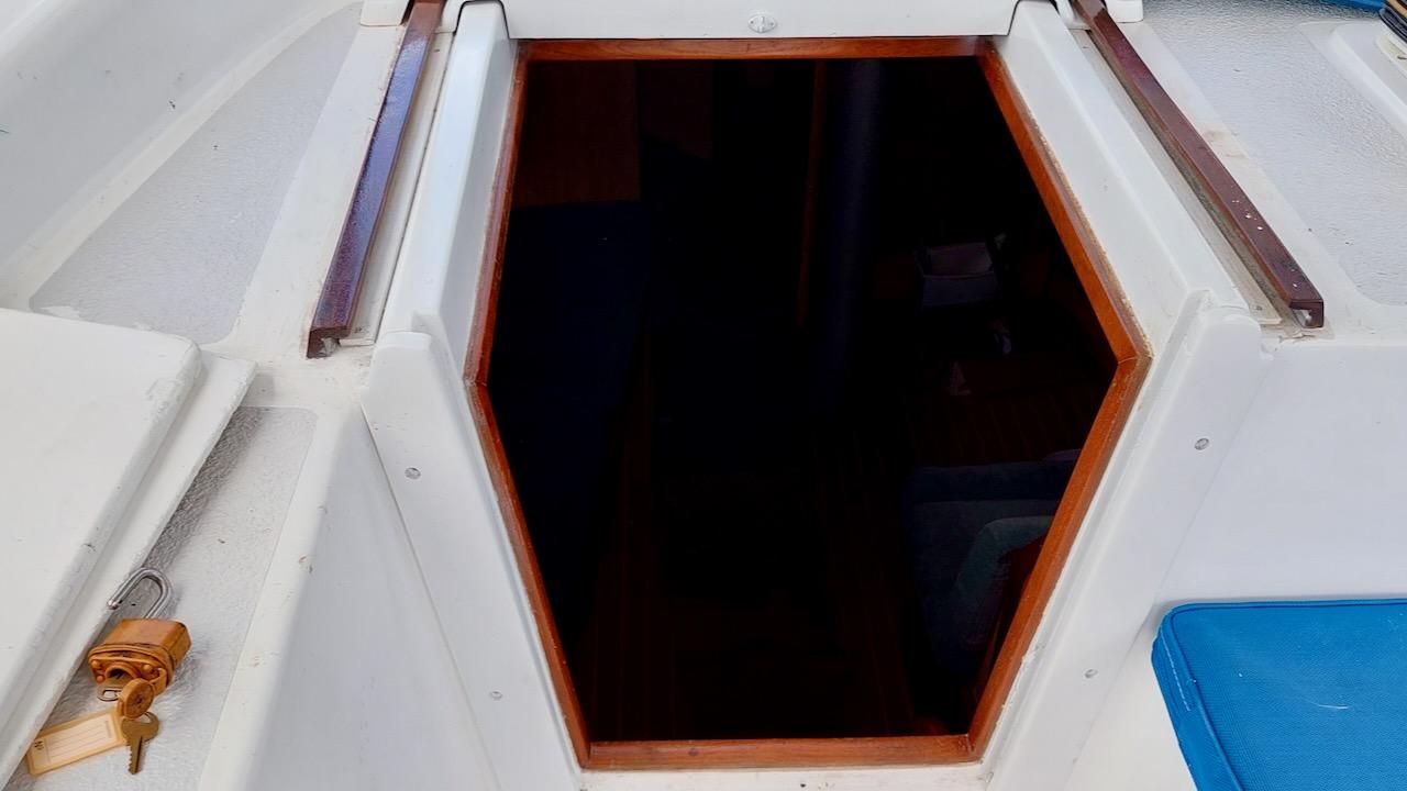 1981 Morgan Out Island 41 sailboat cabin entrance with wooden trim and white deck.