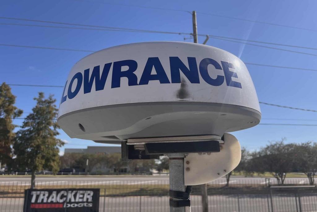 Lowrance radar on a 1997 Gravois 20CC boat, clear sky background.