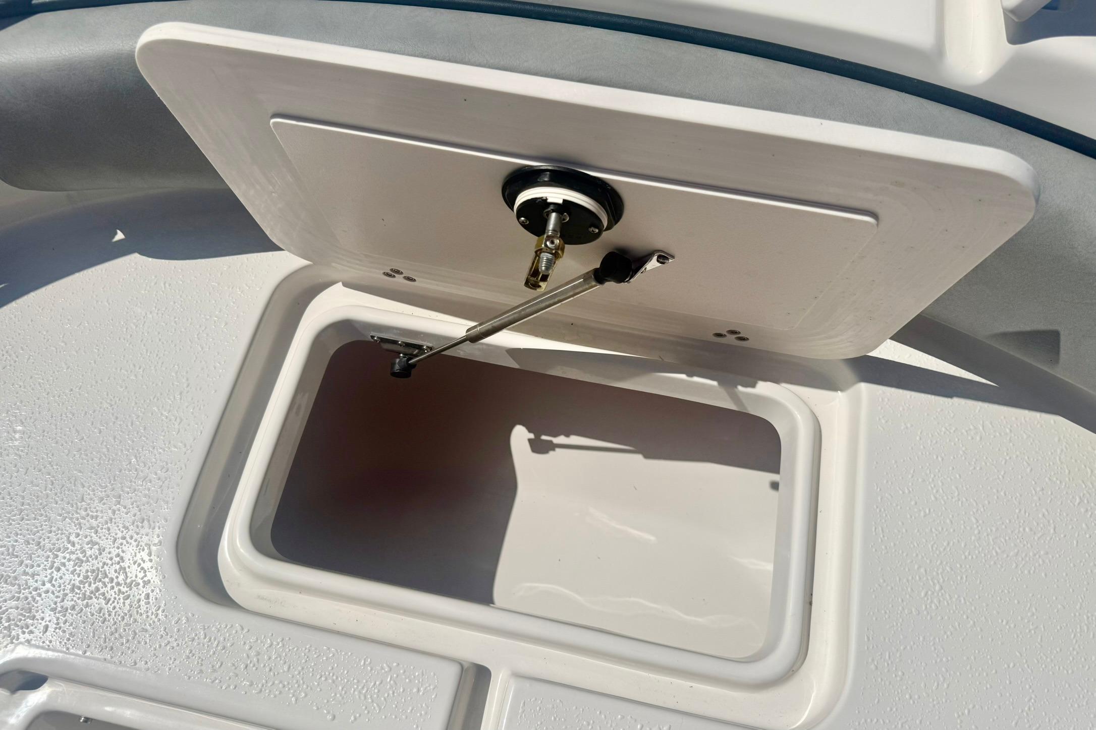 2026 Carolina Skiff 21 Ultra Elite storage compartment with open hatch, showcasing interior space.