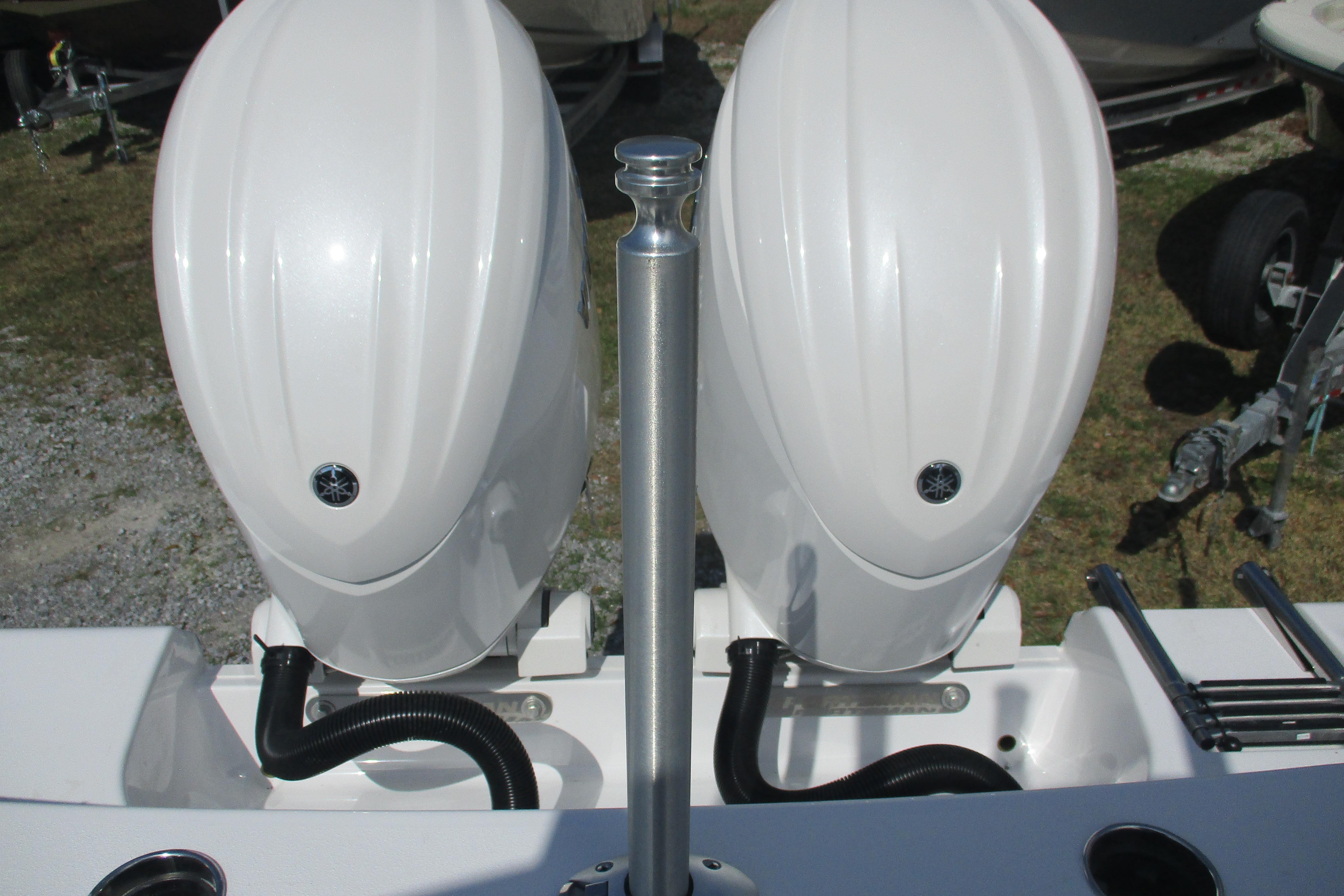 2026 Sportsman Open 252 Center Console with dual outboard engines, rear view.