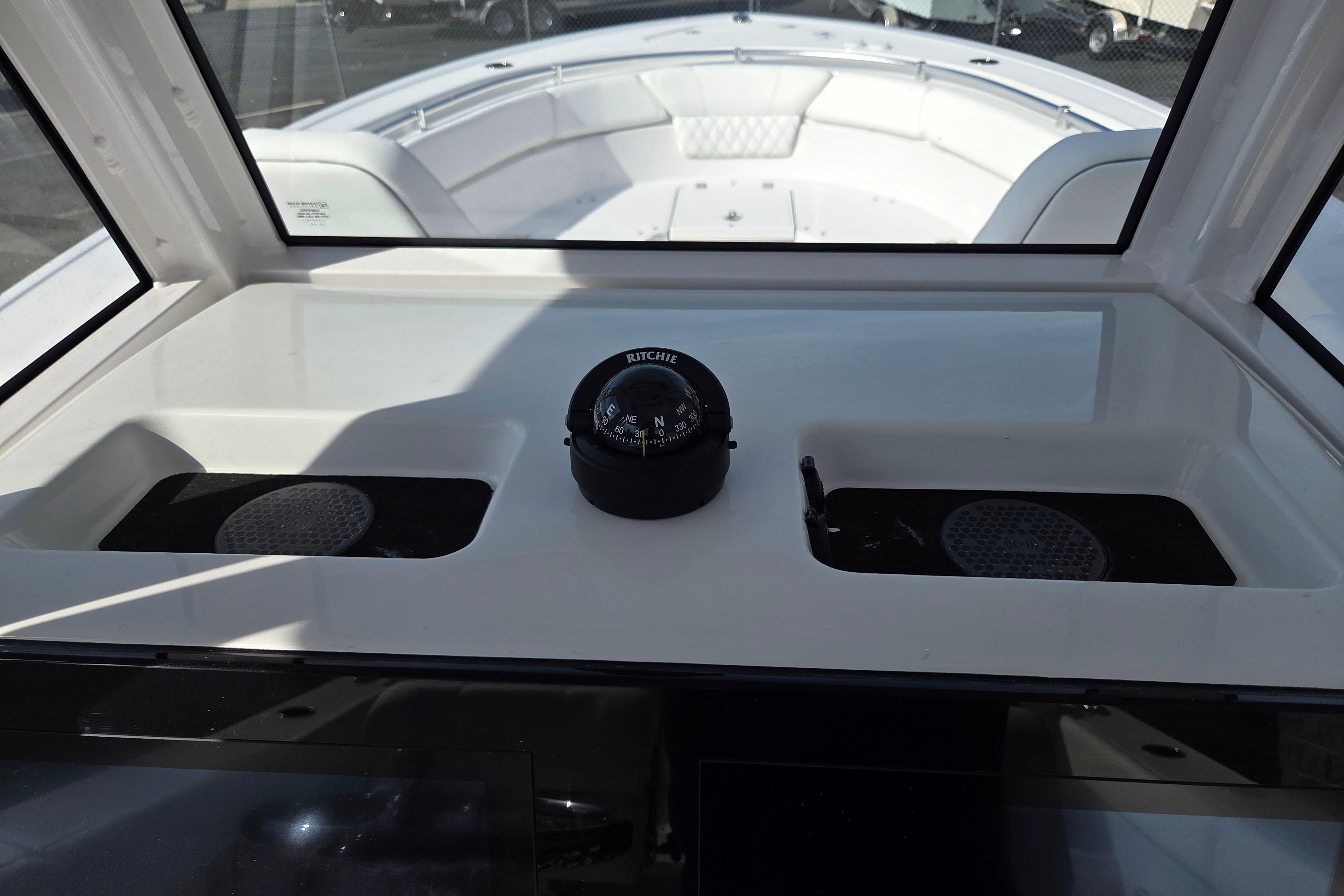 2026 Sportsman Heritage 261 Center Console dashboard with compass and storage compartments.