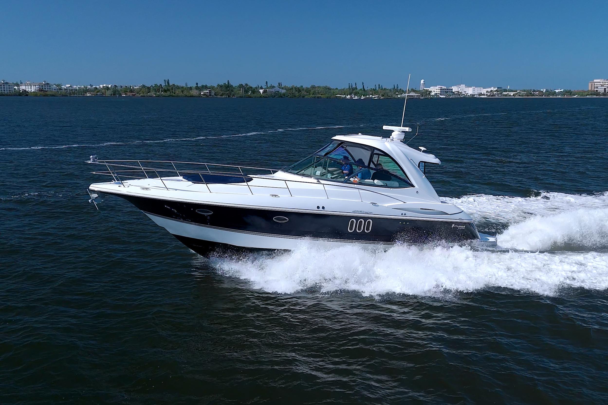 2008 Cruisers Yachts 420 Express cruising on open water under clear blue skies.