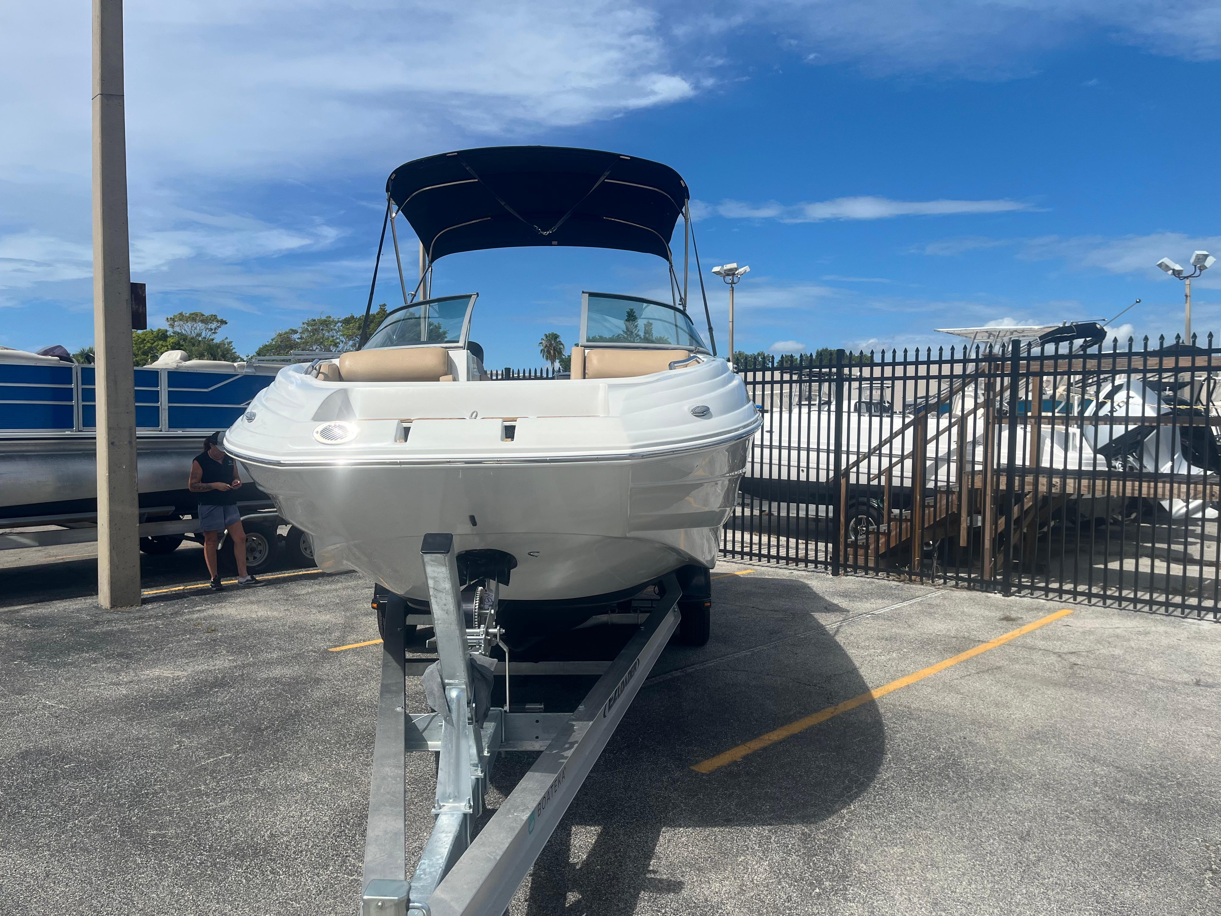 2022 Crownline Eclipse E235 XS boat on trailer in parking lot.