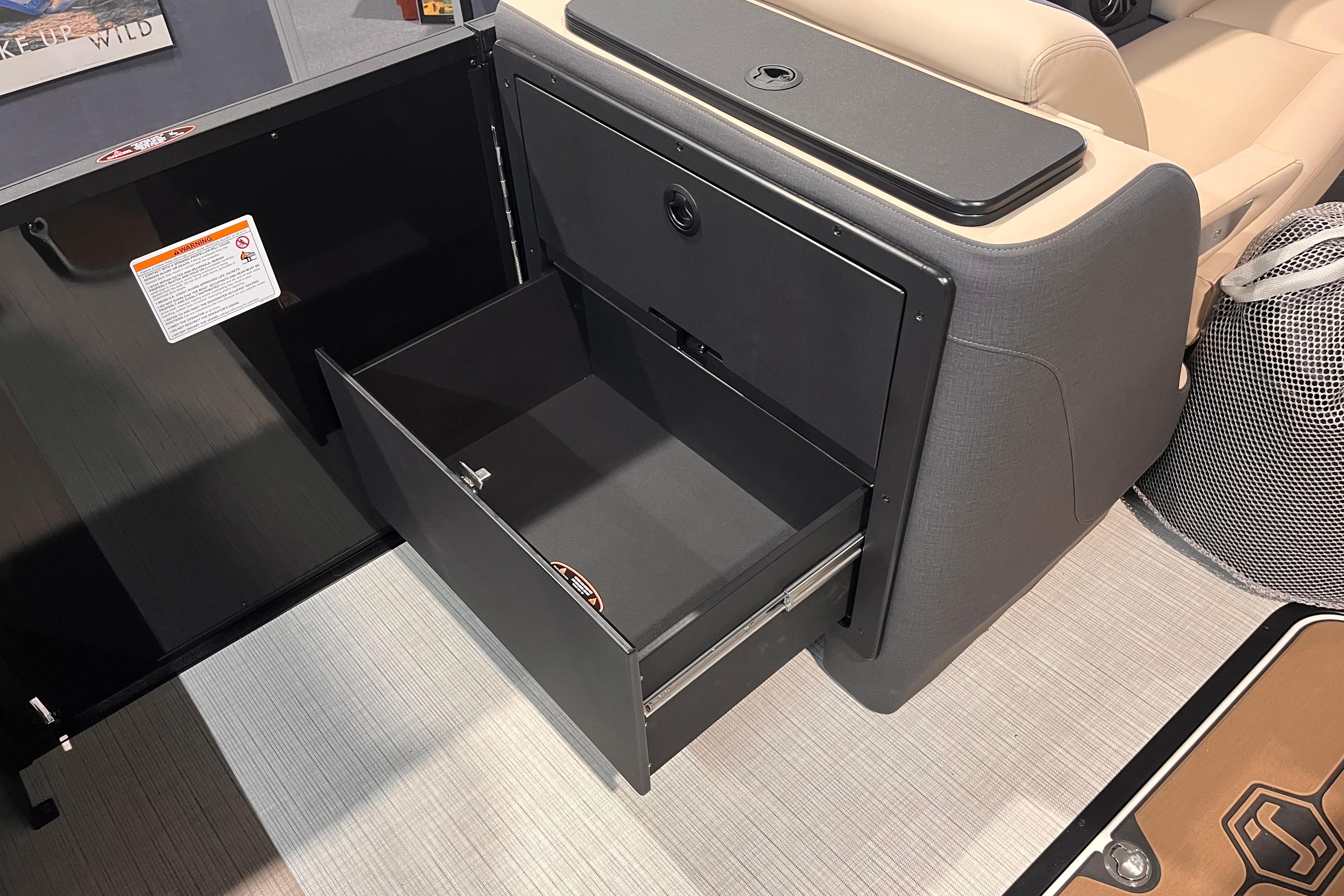 Open storage compartment in 2026 Harris Sunliner 250 boat interior.
