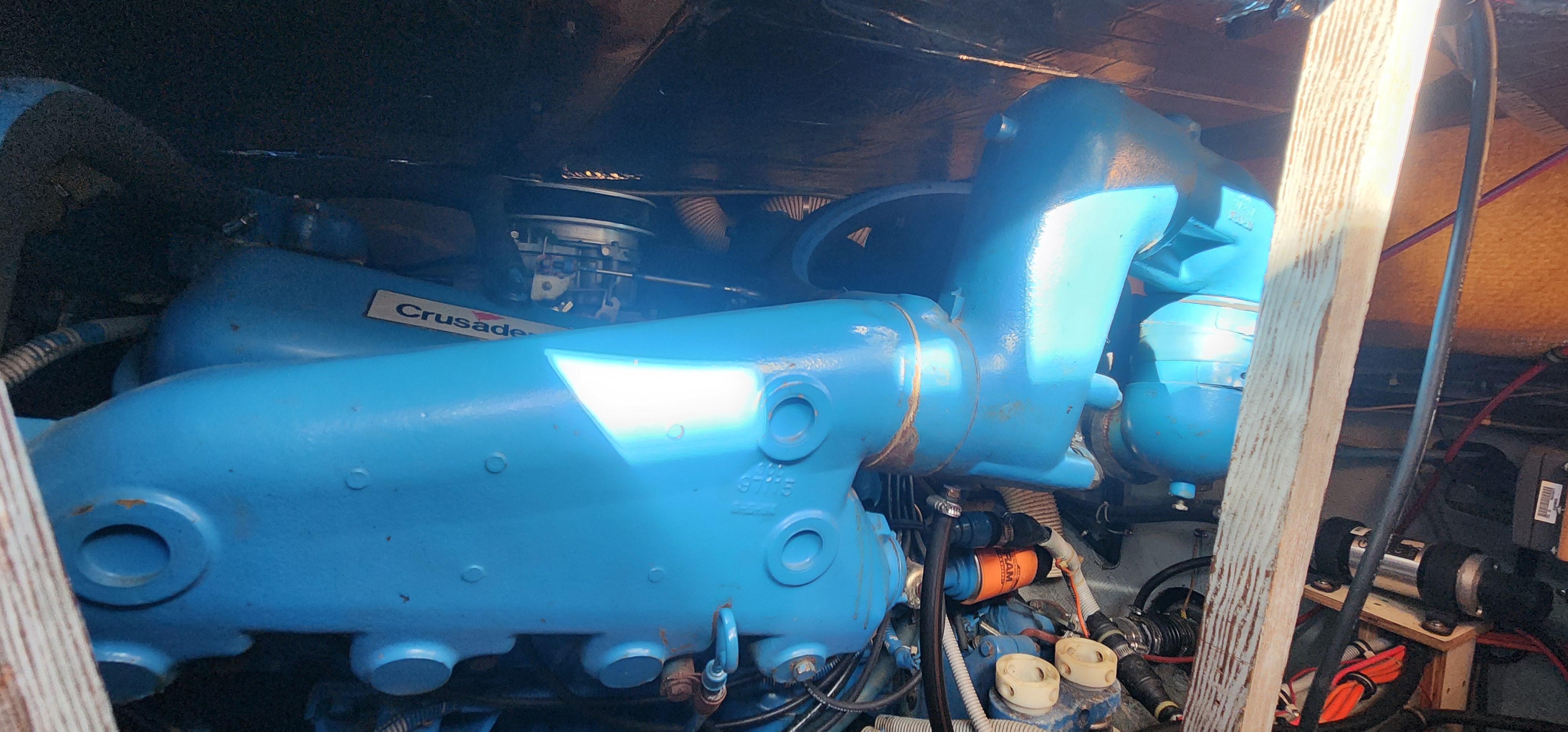 Engine compartment of a 1985 Bertram 33 Flybridge Cruiser with blue components.