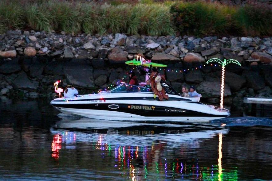 2013 Crownline Eclipse E4 boat decorated with lights and tropical theme, cruising on water.