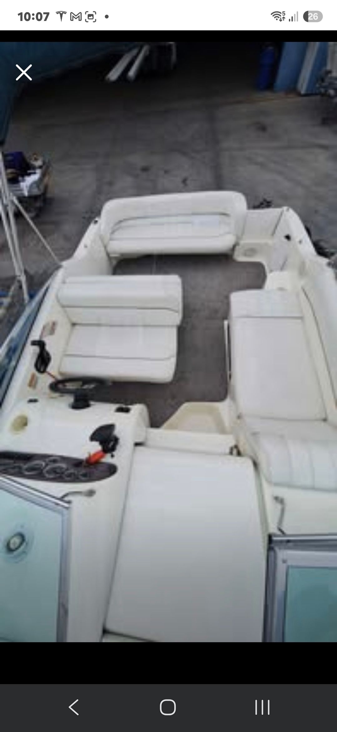 The image shows the cockpit of a 1998 Sea Ray 240 Sundancer with white seating.