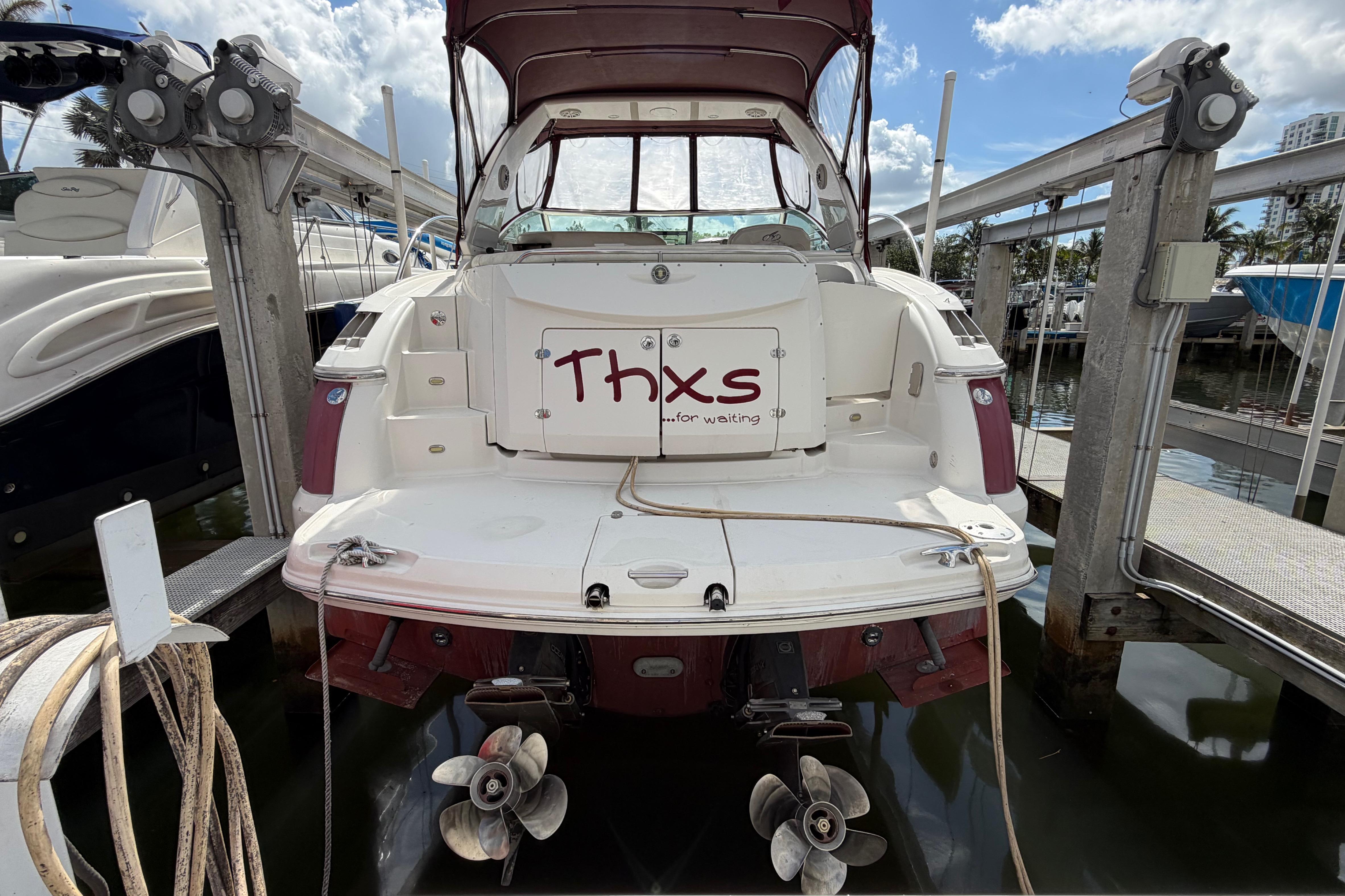 2007 Monterey 350 Sport Yacht docked, rear view with "Thxs for waiting" sign.