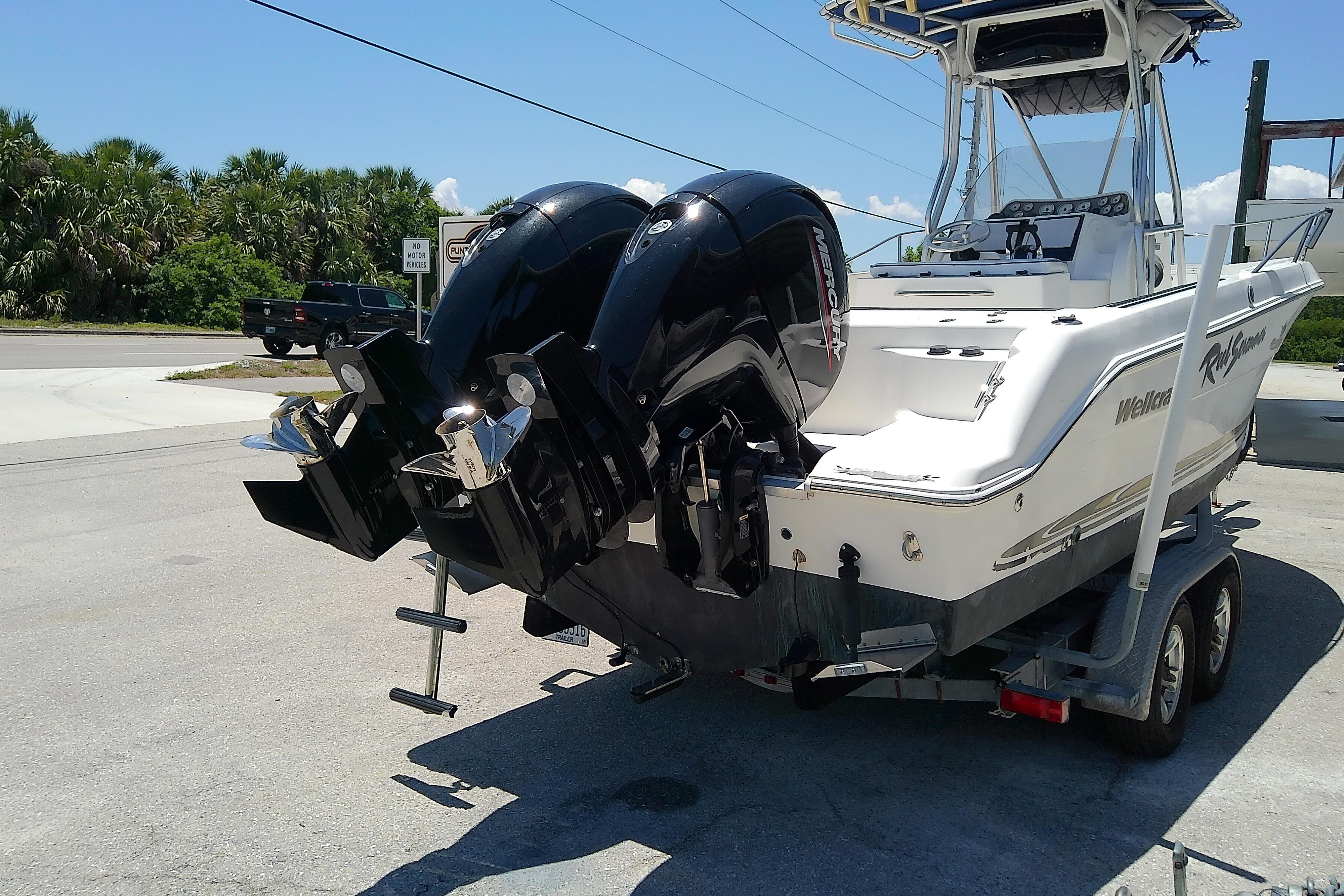 2003 Wellcraft 250 Fisherman boat on trailer with dual outboard motors.