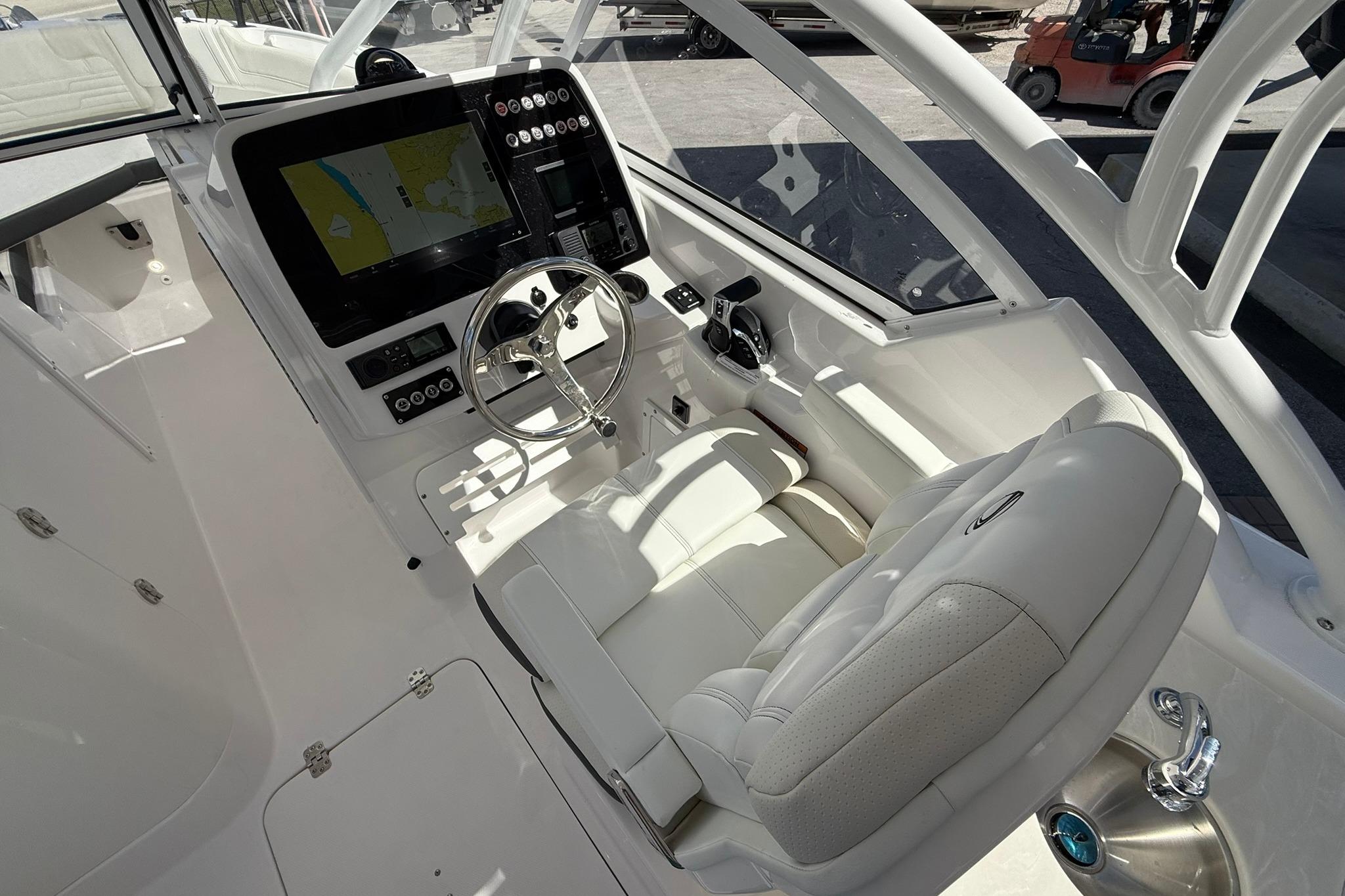 Interior of 2026 Edgewater 248CX Crossover boat with modern dashboard and steering wheel.