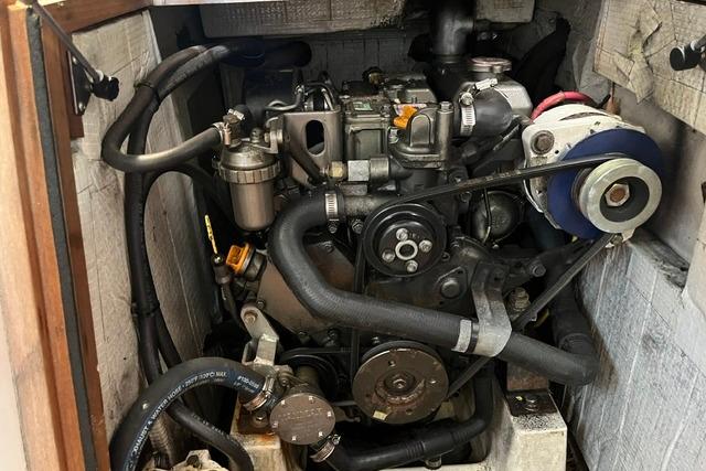 Engine compartment of a 2006 Morris 36, showcasing mechanical components and hoses.