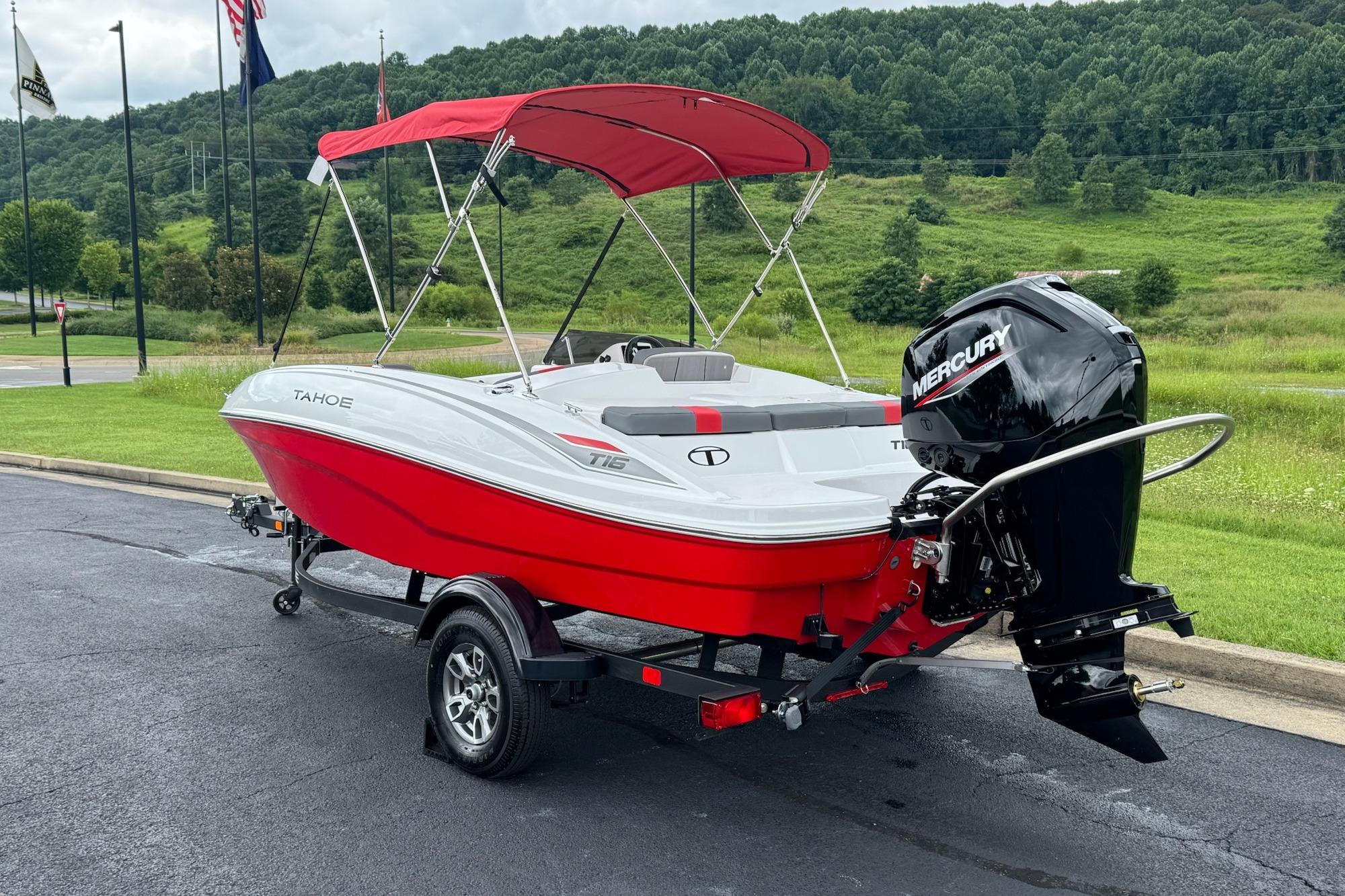 2026 Tahoe T16 boat with red canopy and Mercury engine on trailer.