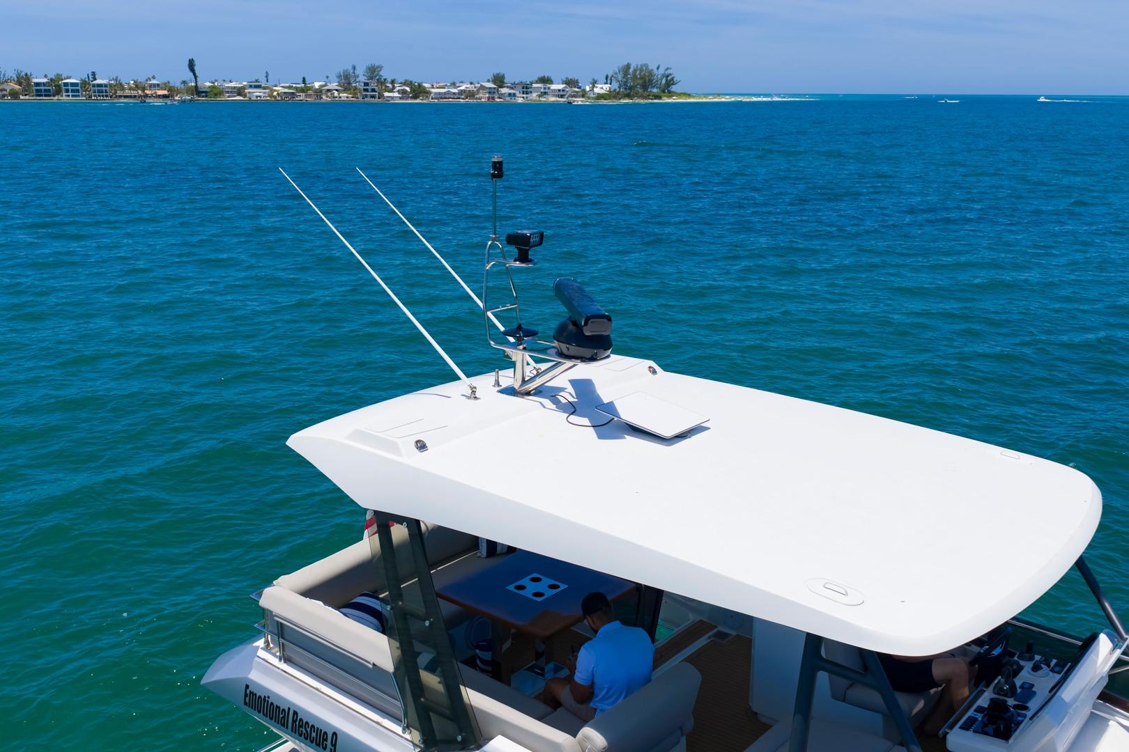 Prestige 520 yacht cruising on blue waters, 2022 model, with scenic coastal backdrop.