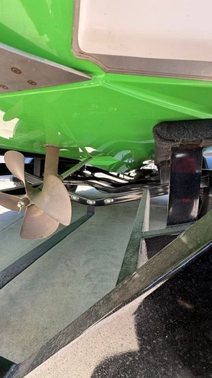 Close-up of the green hull of a 2018 Nautique Super Air Nautique G23 on a trailer.