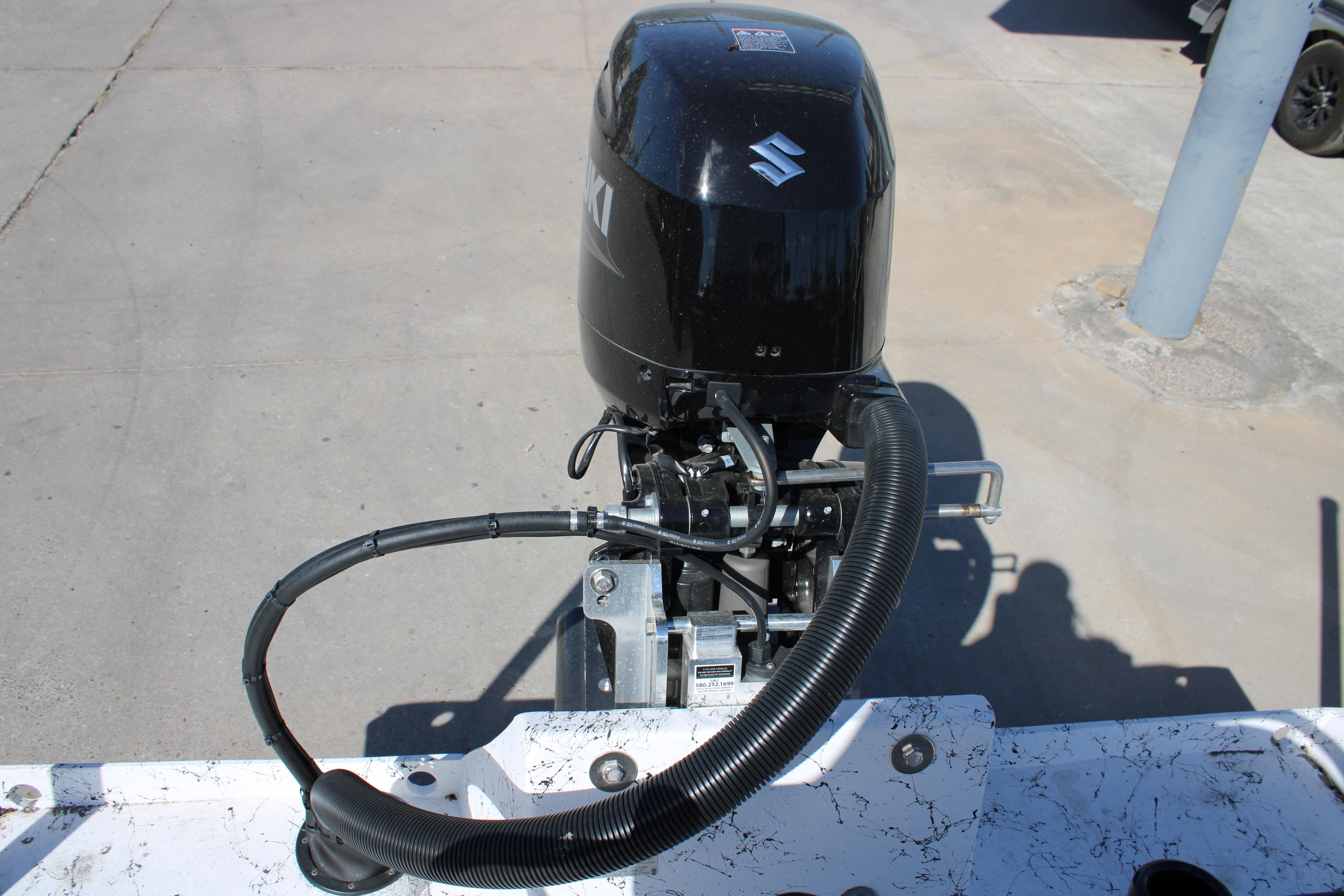 Outboard motor on a 2026 Freedom Boats Chiquita, showcasing engine details.