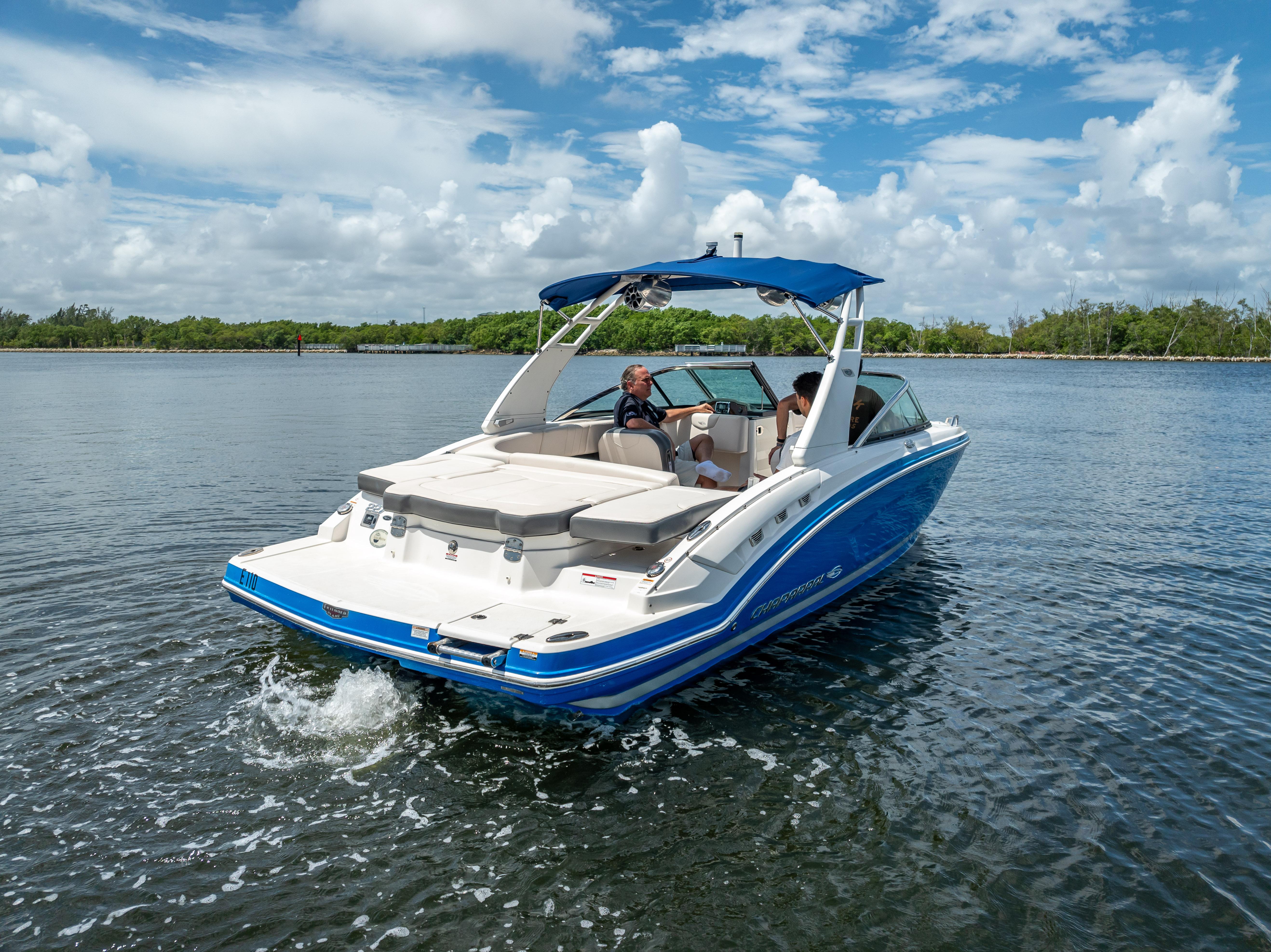 2017 Chaparral 227 SSX boat cruising on a sunny day with blue skies.