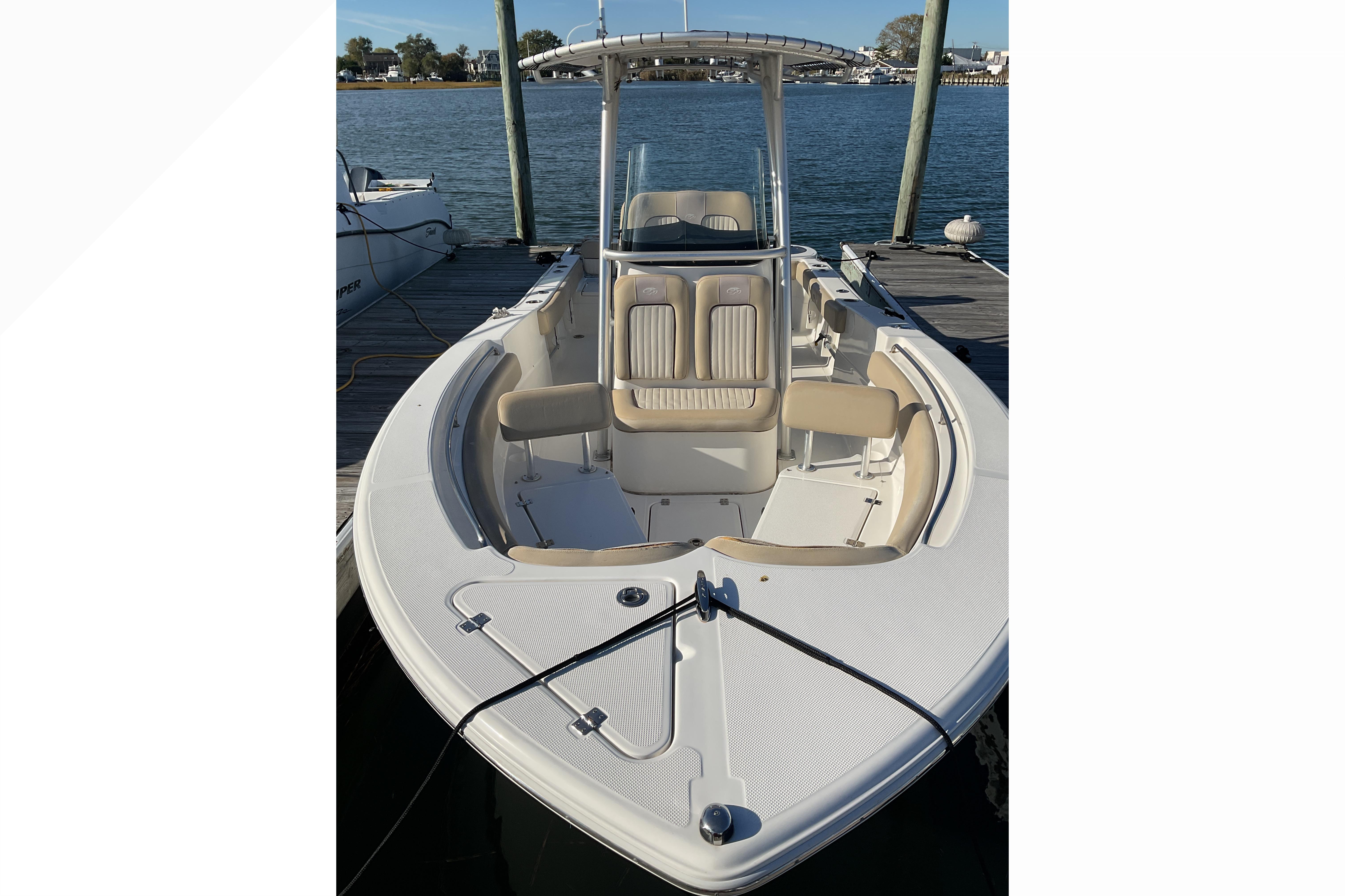 2016 Sea Fox 226 Commander boat docked, featuring spacious seating and sleek design.