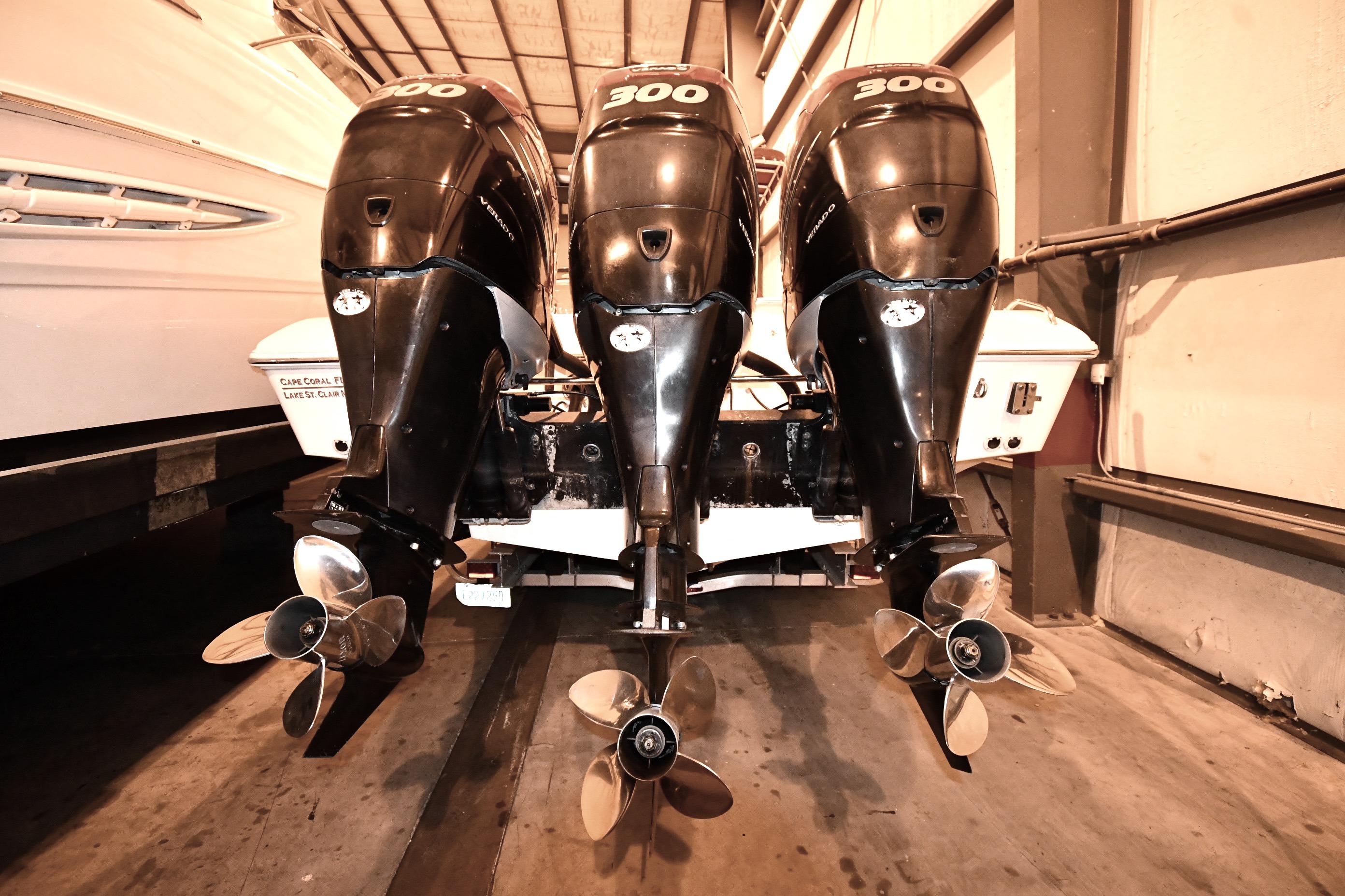 Triple outboard engines on a 2001 Fountain 38 Center Console boat in storage.