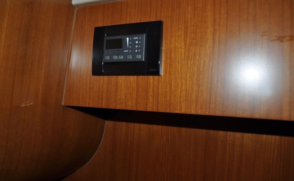 A control panel is embedded in a wooden wall.
