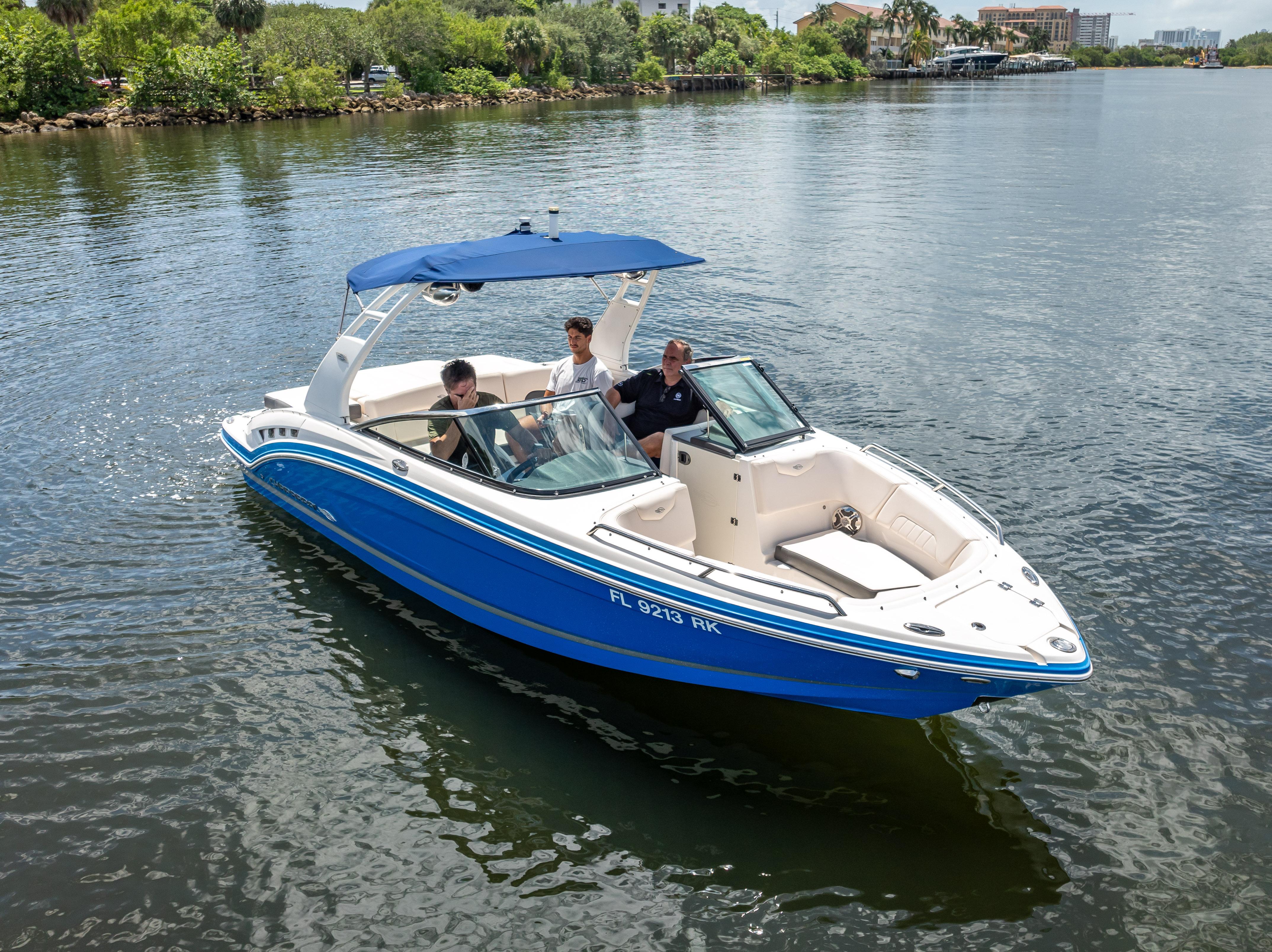 2017 Chaparral 227 SSX boat cruising on a calm river with passengers onboard.