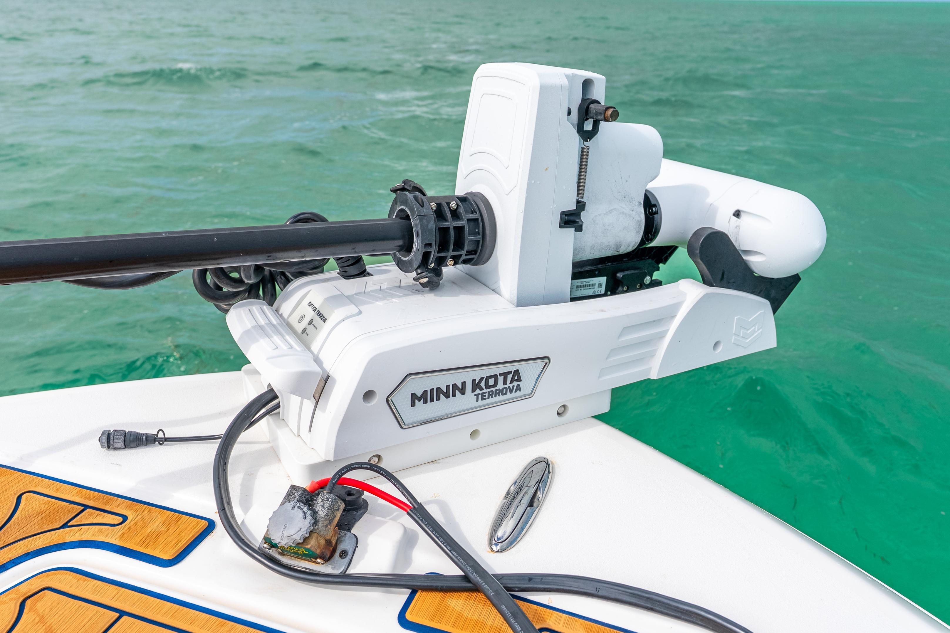 2024 Caymas 281 HB with Minn Kota Terrova trolling motor on turquoise water.