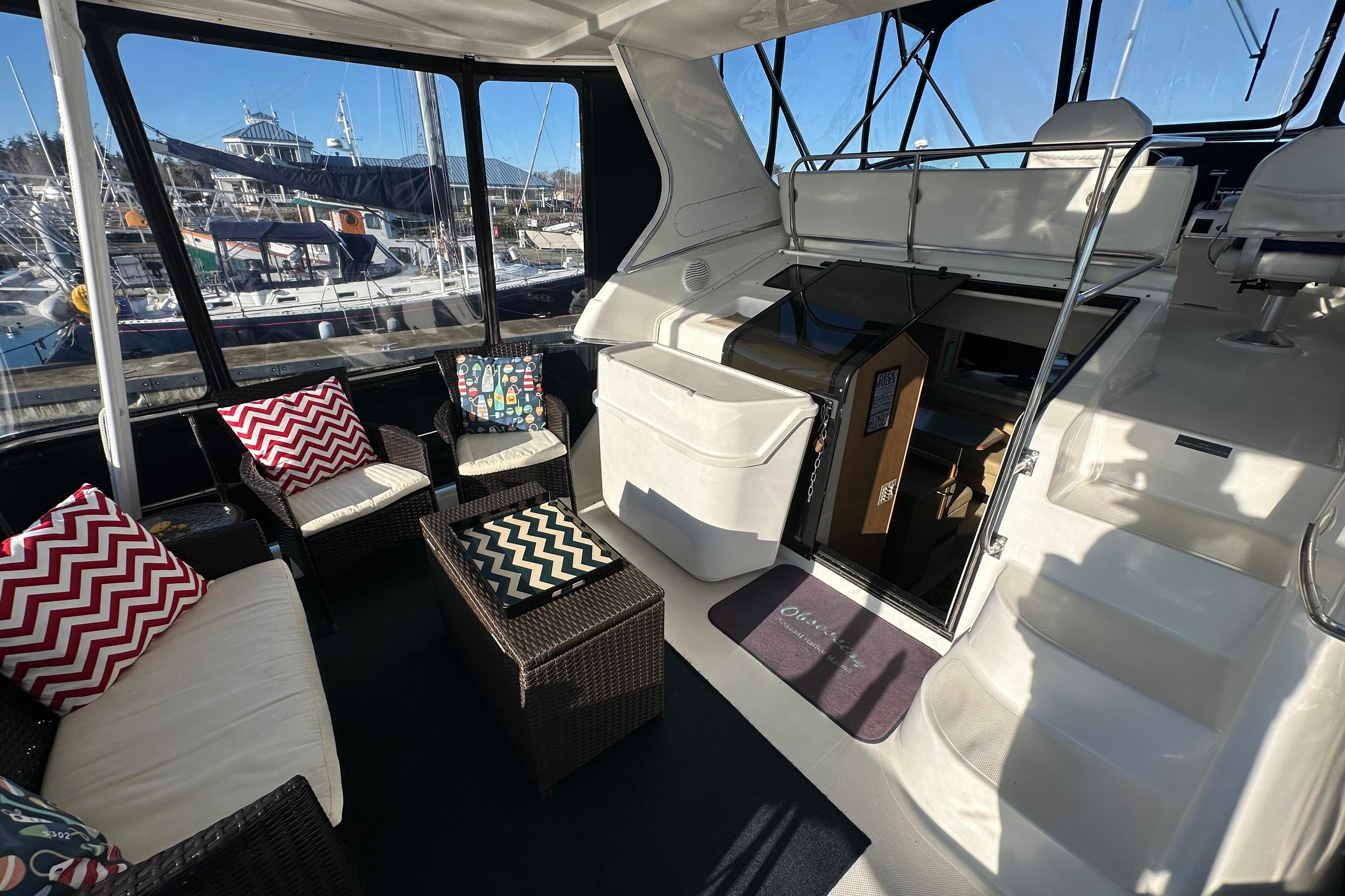 2000 Bayliner 4087 Aft Cabin Motoryacht interior with seating and marina view.