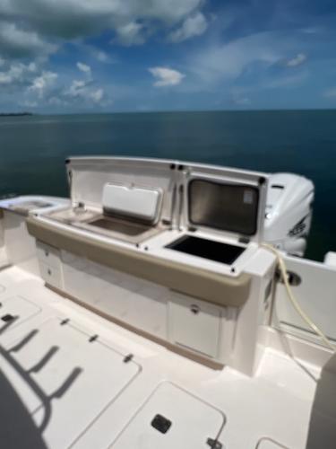 2019 Pursuit S 408 Sport boat with open deck and ocean view.