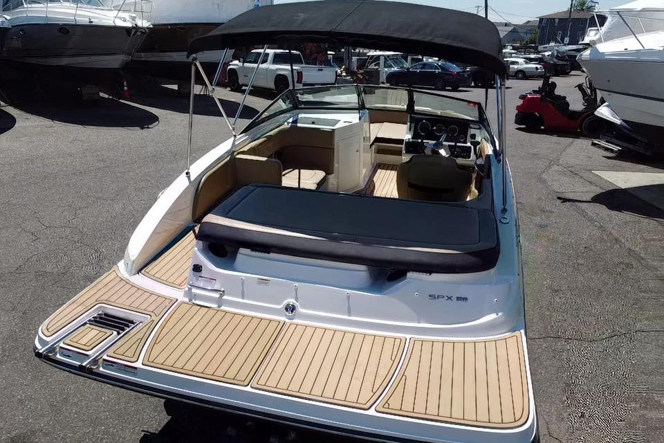 2021 Sea Ray SPX 190 boat with sleek design and spacious deck in a marina setting.