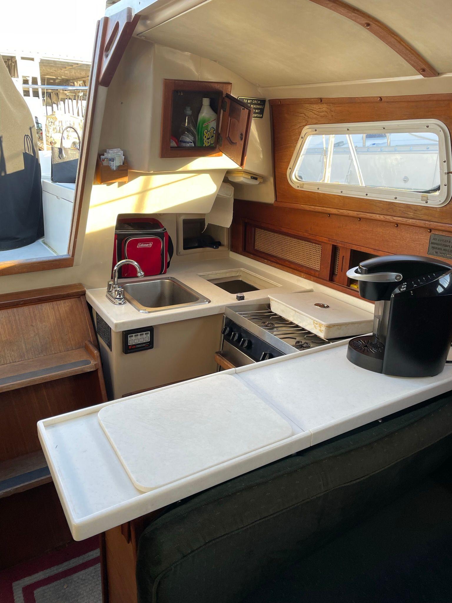Interior view of a 1982 Newport 33 featuring a kitchen and seating area.