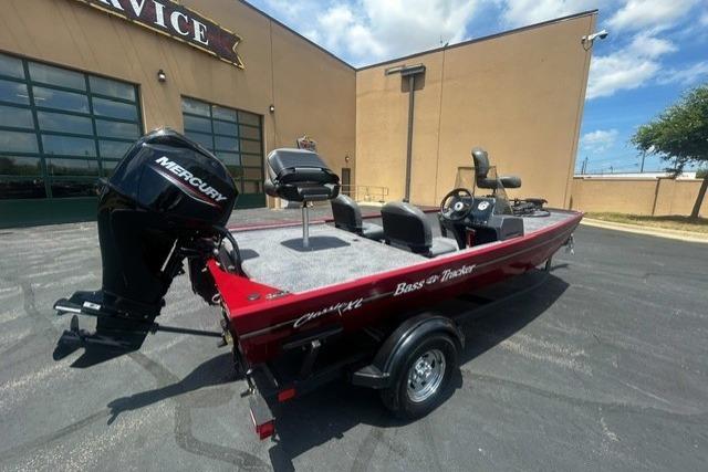 2026 Tracker Bass Tracker Classic XL boat with Mercury engine, parked outdoors.