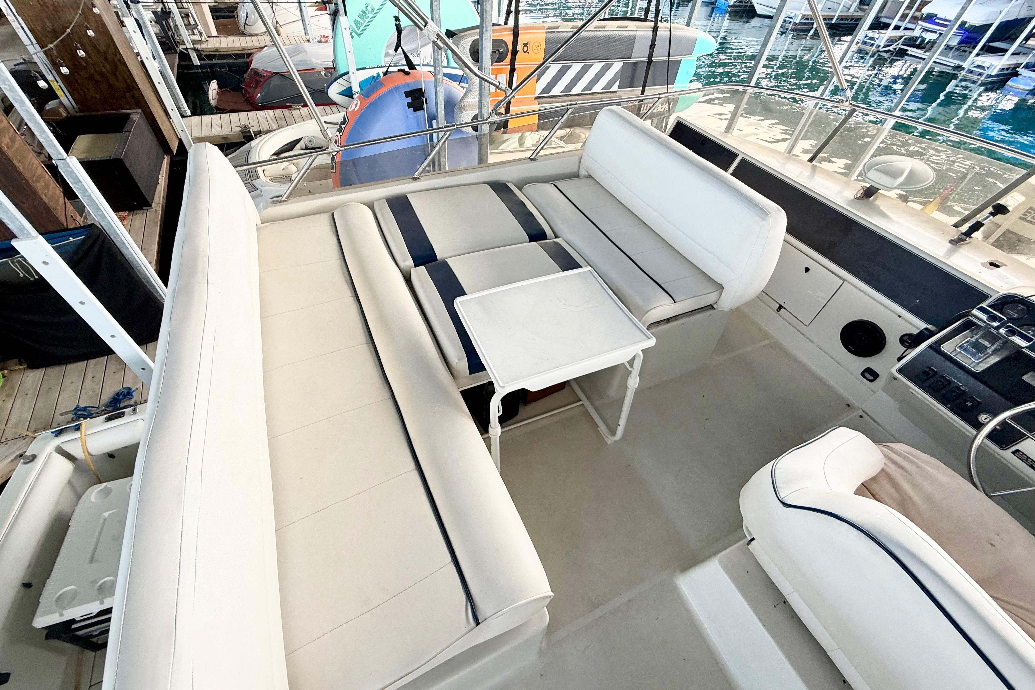 Interior of a 1992 Carver 28 Command Bridge with seating and table setup.