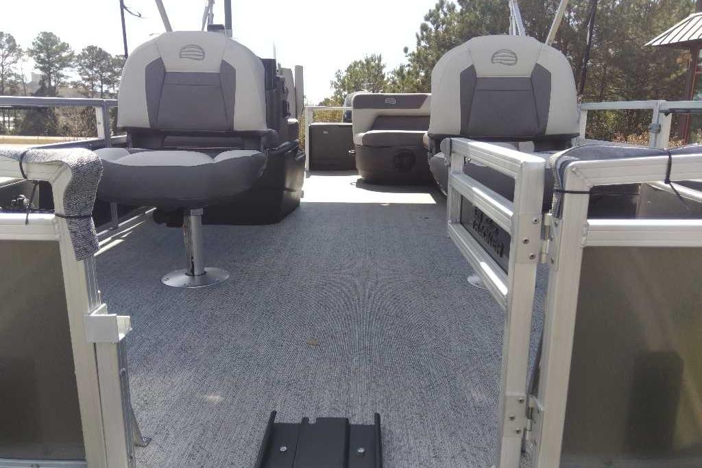 2026 Sun Tracker Bass Buggy 18 DLX pontoon boat interior with seating and carpeted deck.