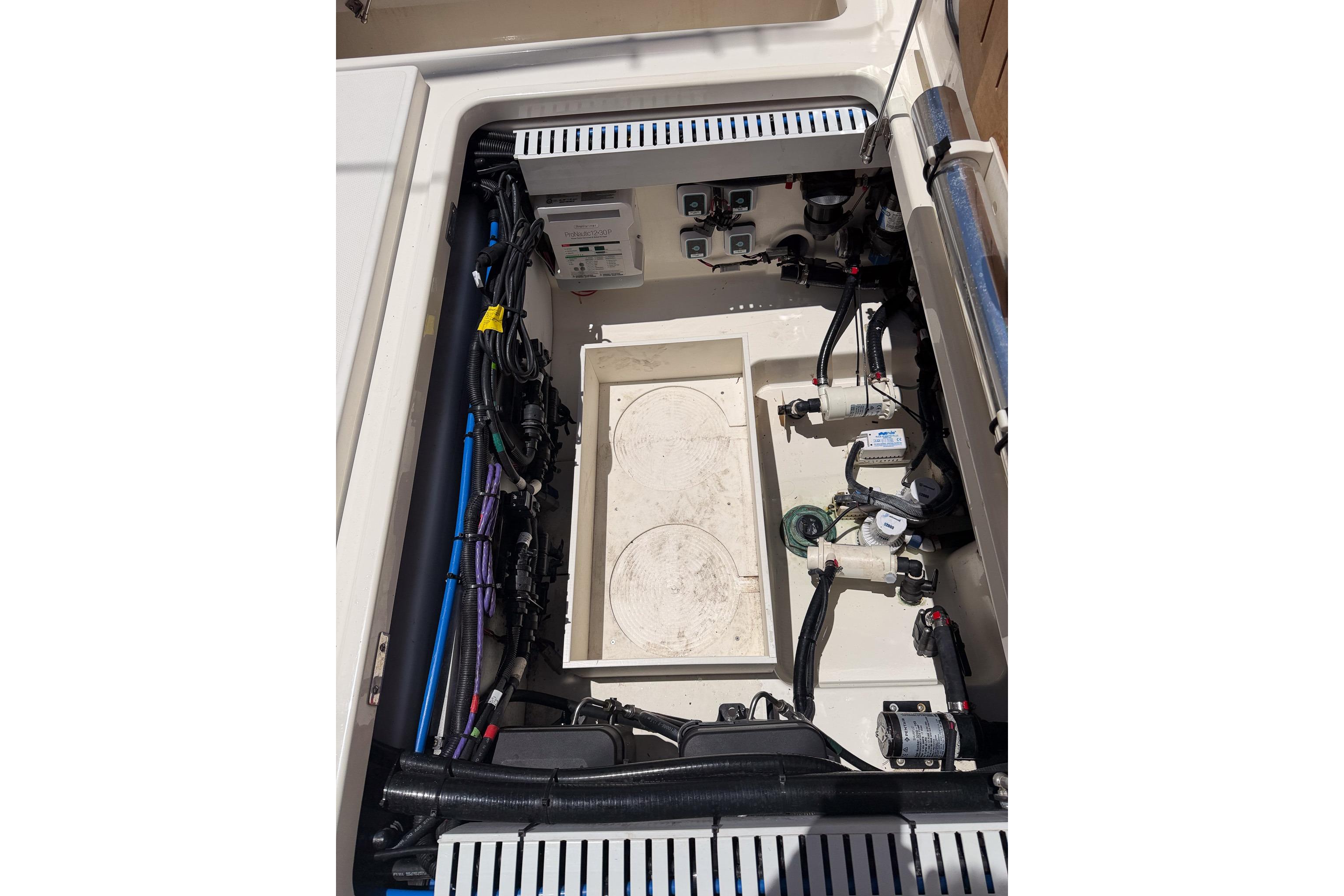 2021 Boston Whaler 330 Outrage engine compartment with wiring and components visible.
