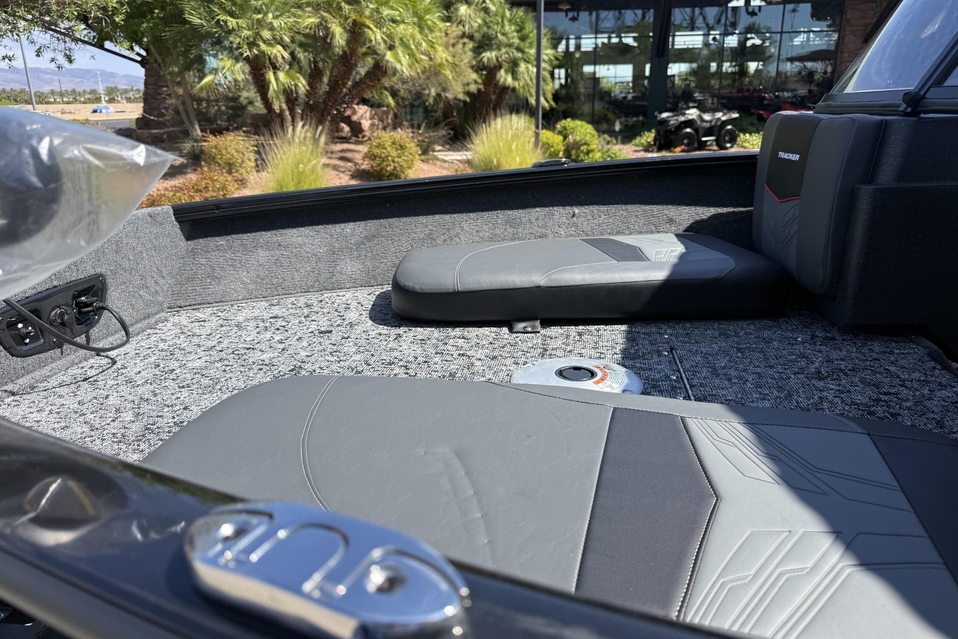 2026 Tracker Pro Guide V-175 Combo boat interior with gray seating and carpeted flooring.